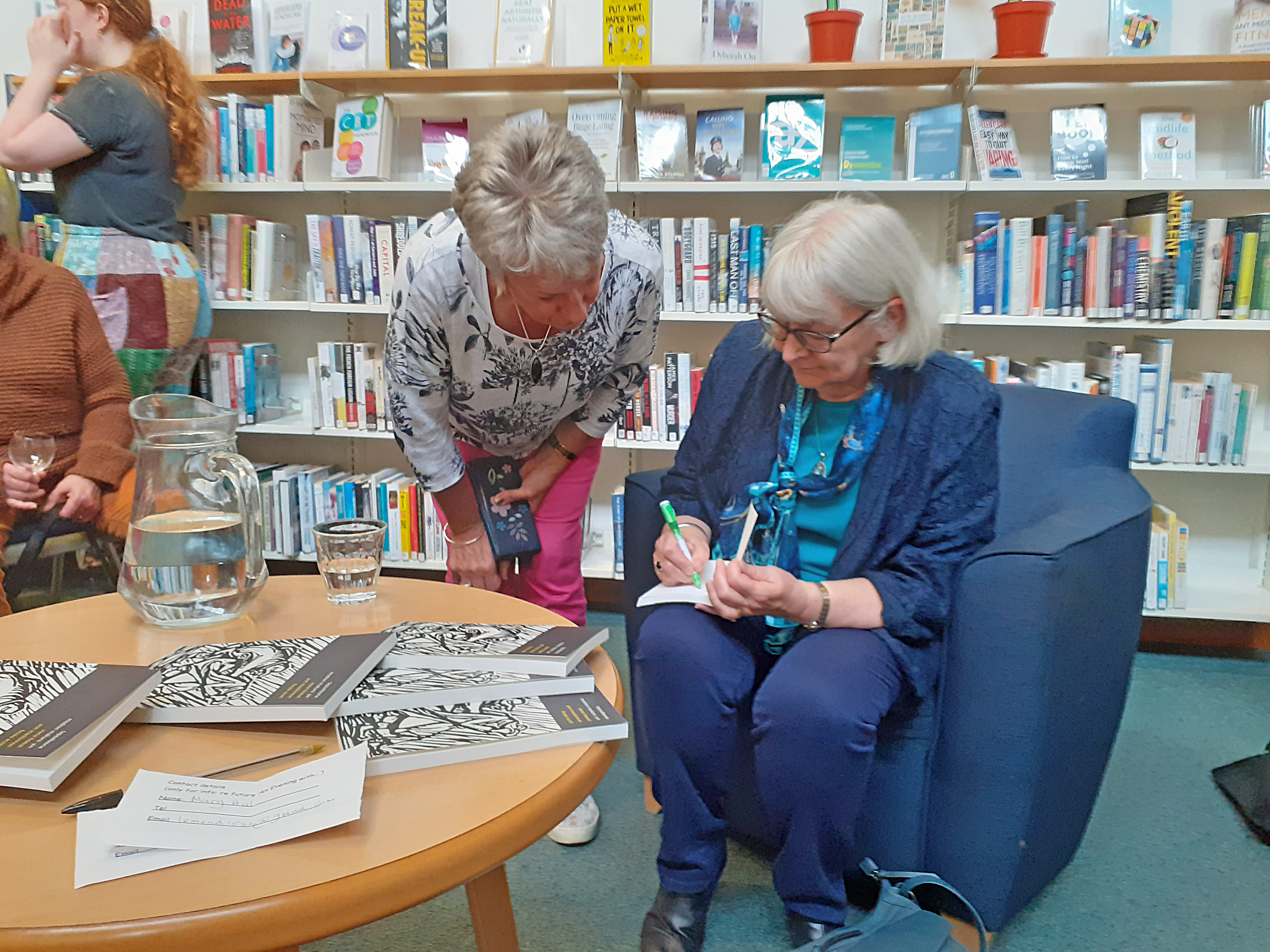 Ann McKinnnon signing copies of the book