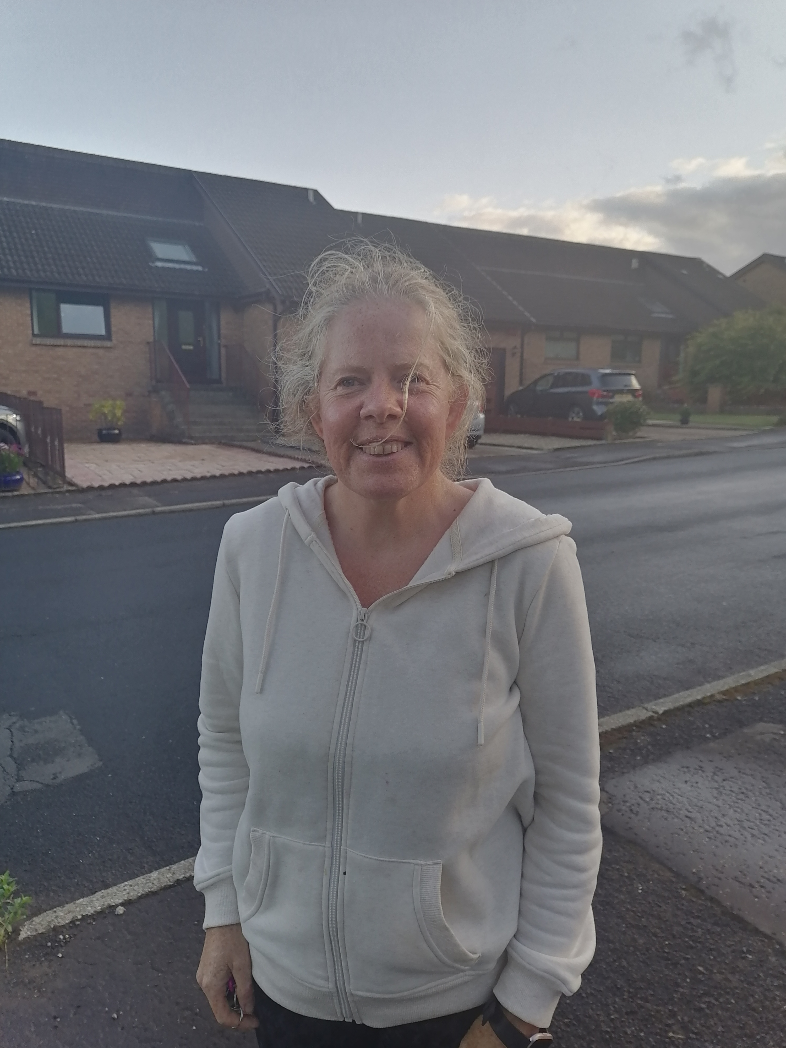 Image of lady with grey hair.