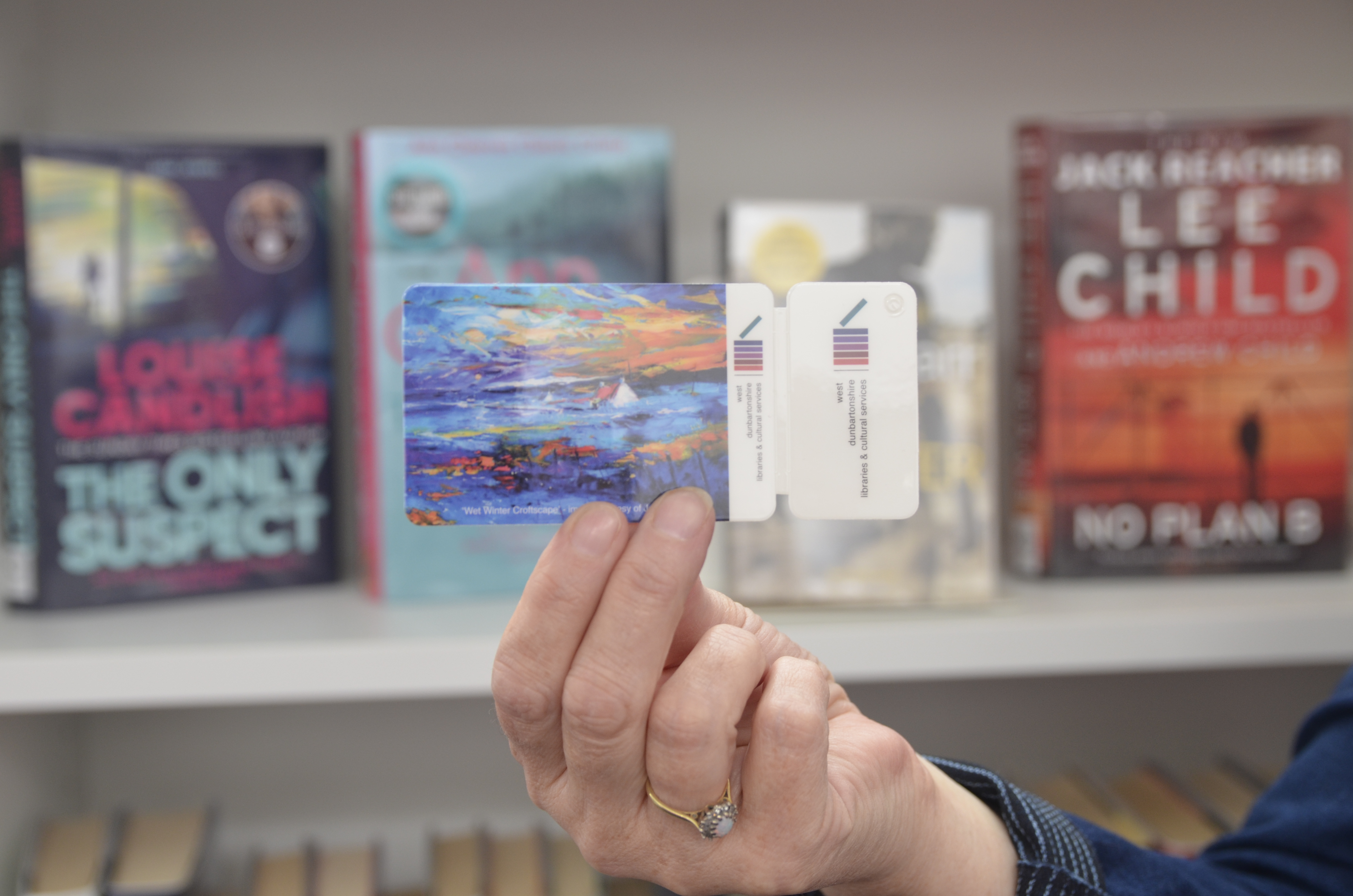 hand holding a library card