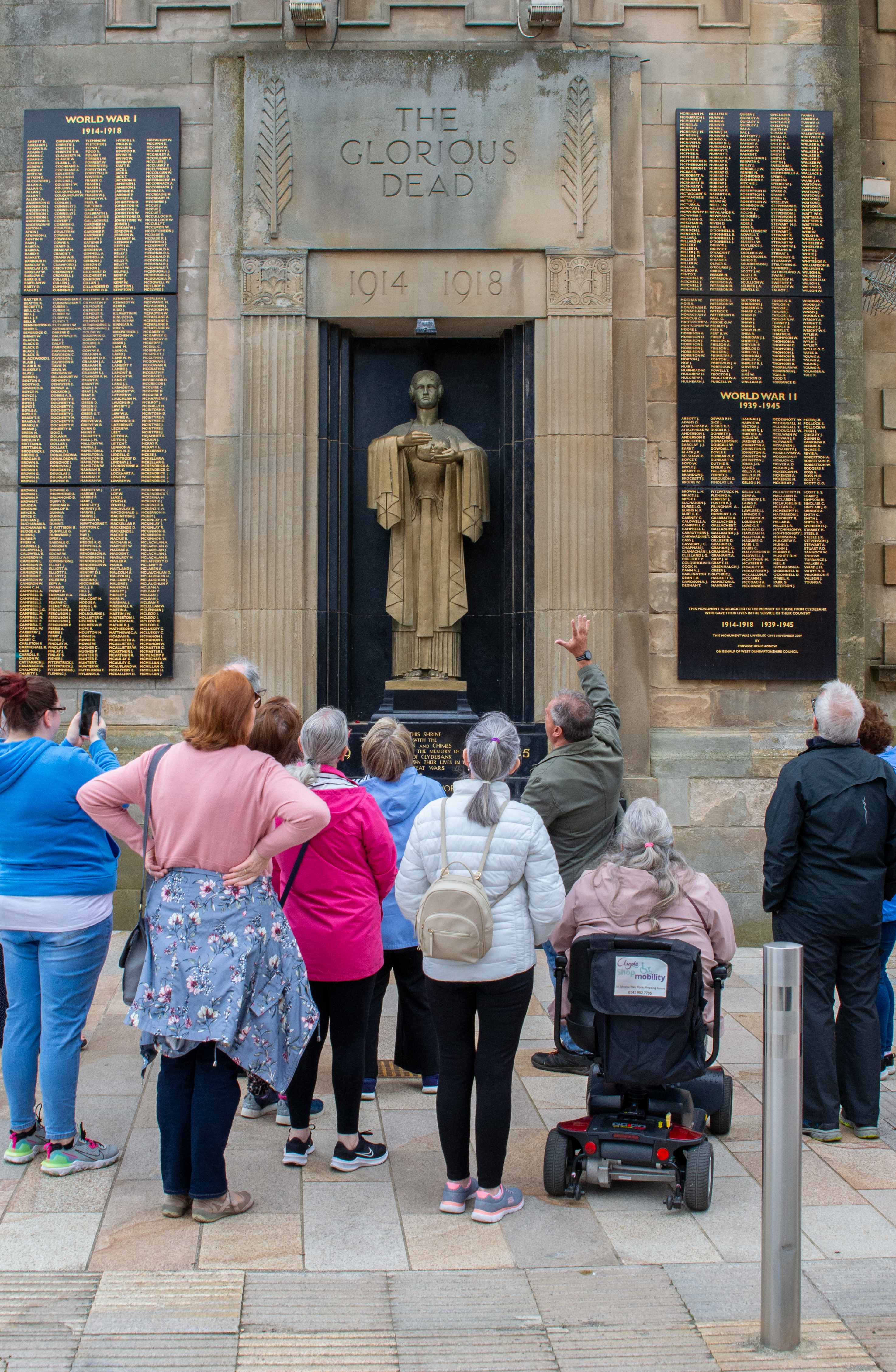 group of people looking up at World War 1 & 2 memorial