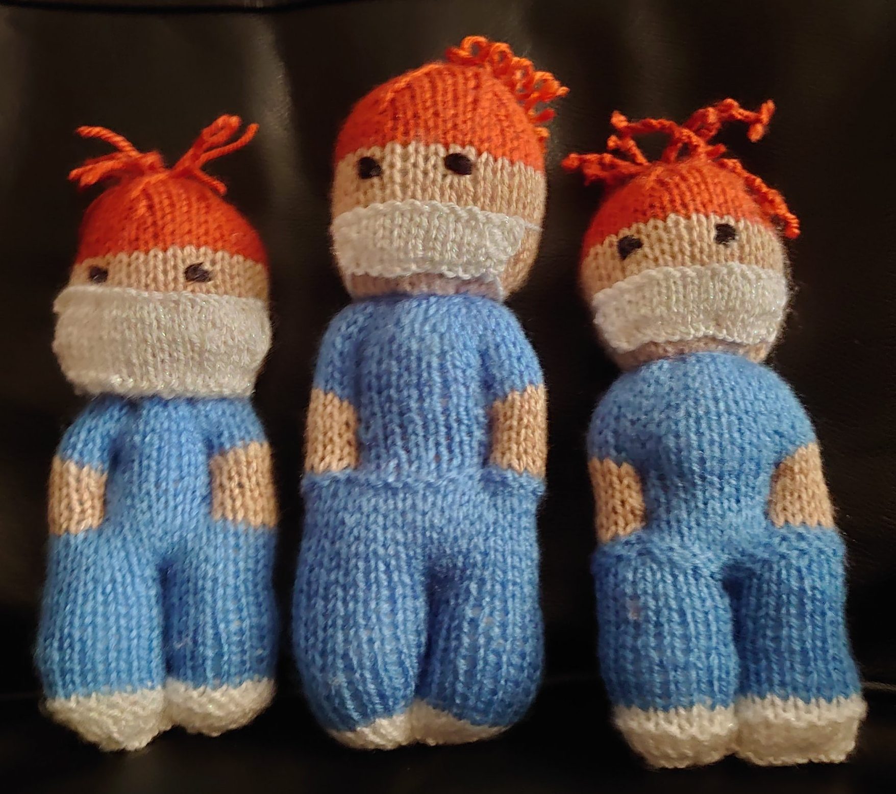 three knitted nurse dolls