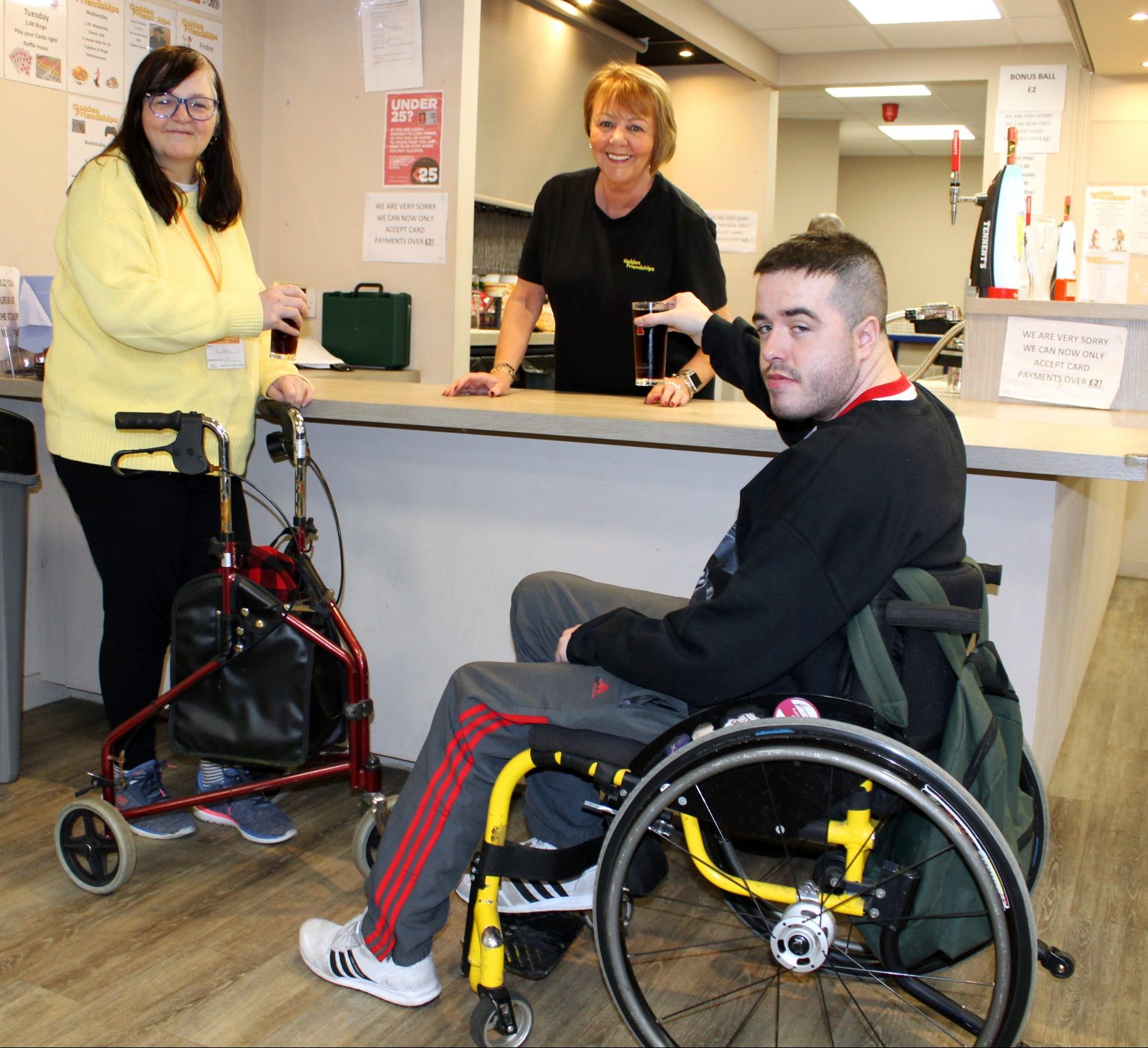 person in wheelchair being served at an adjustable bar