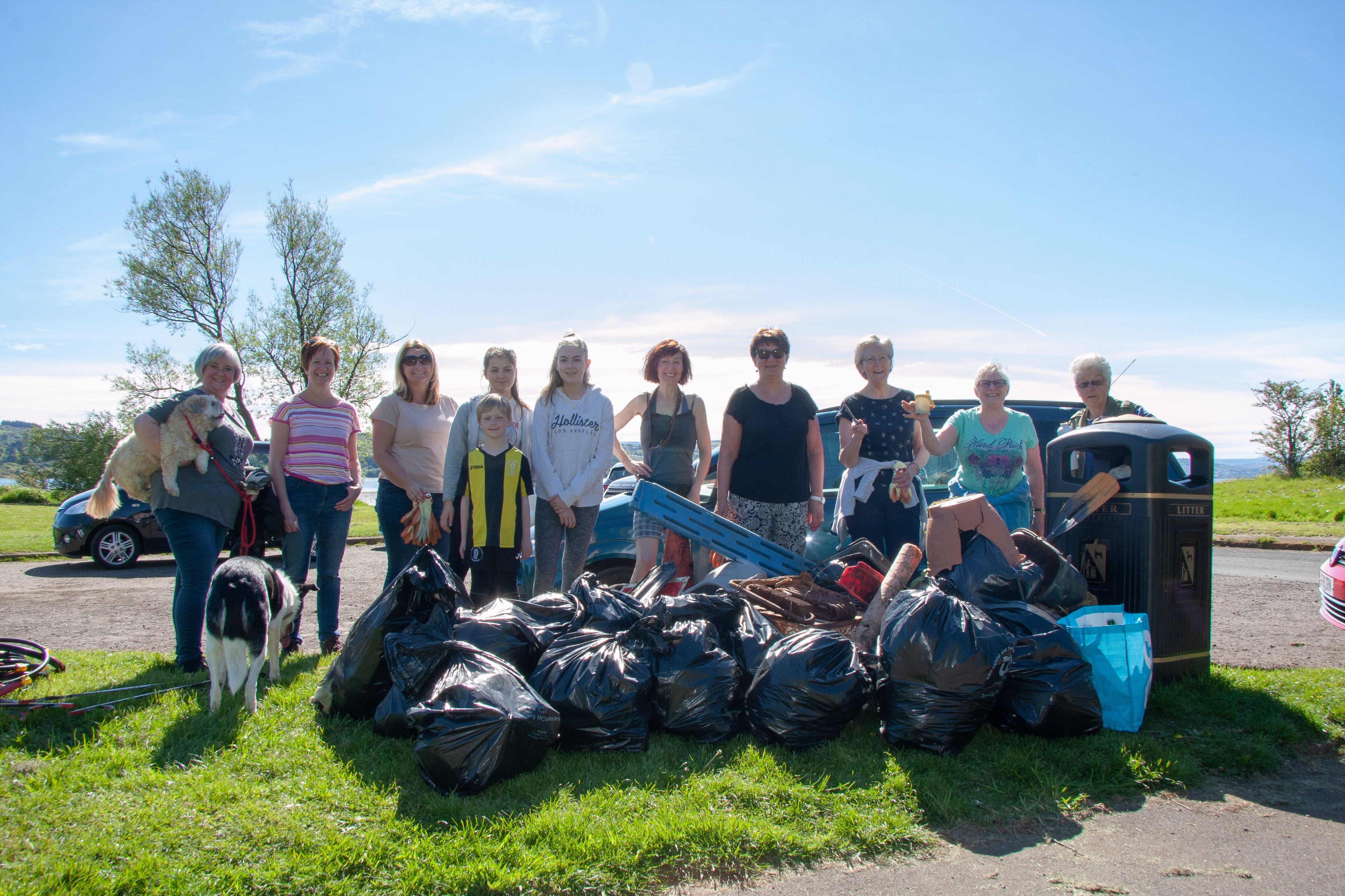 Clyde shore litter pickers with bags of rubbish