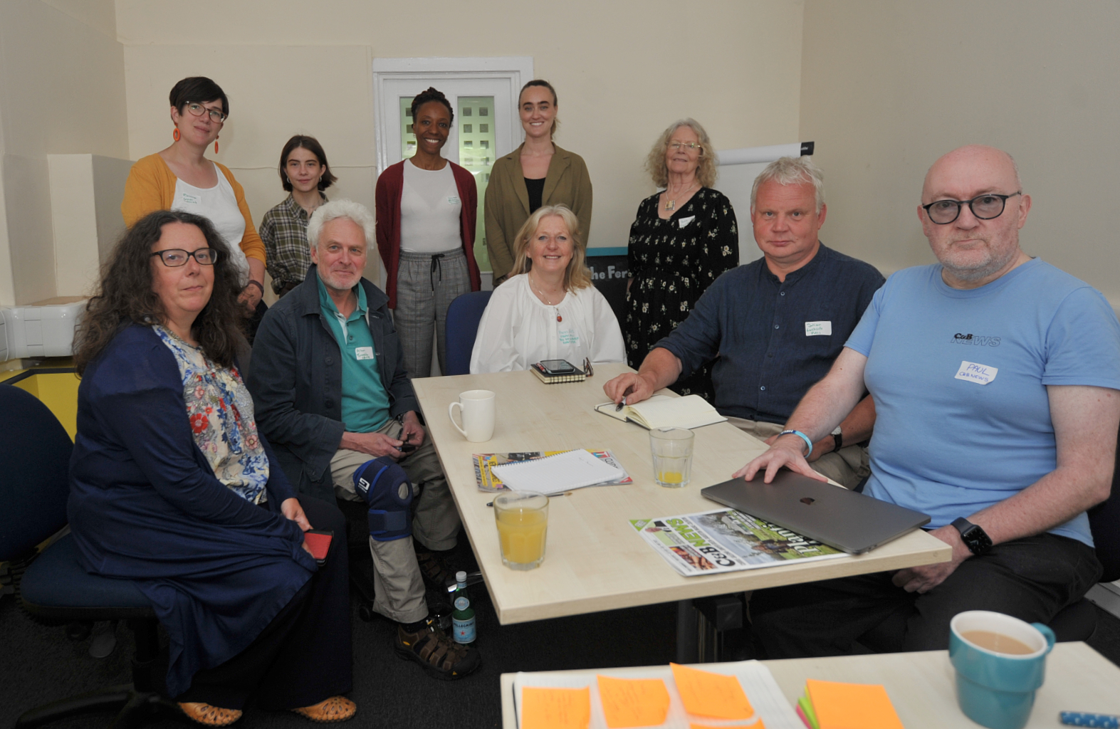 Independent publishers sat at table in a community newsroom