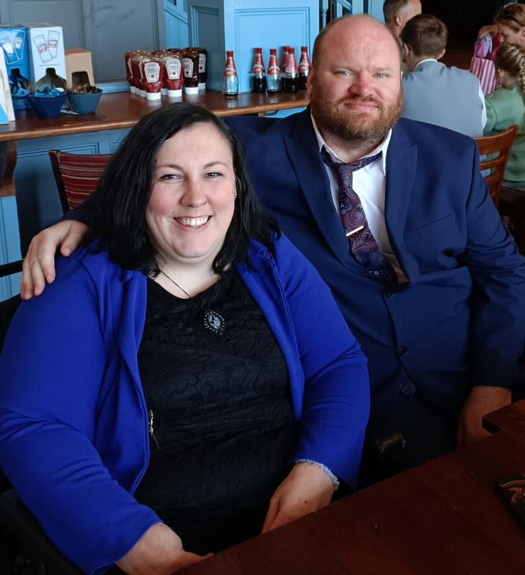 Layla sitting with partner at an event