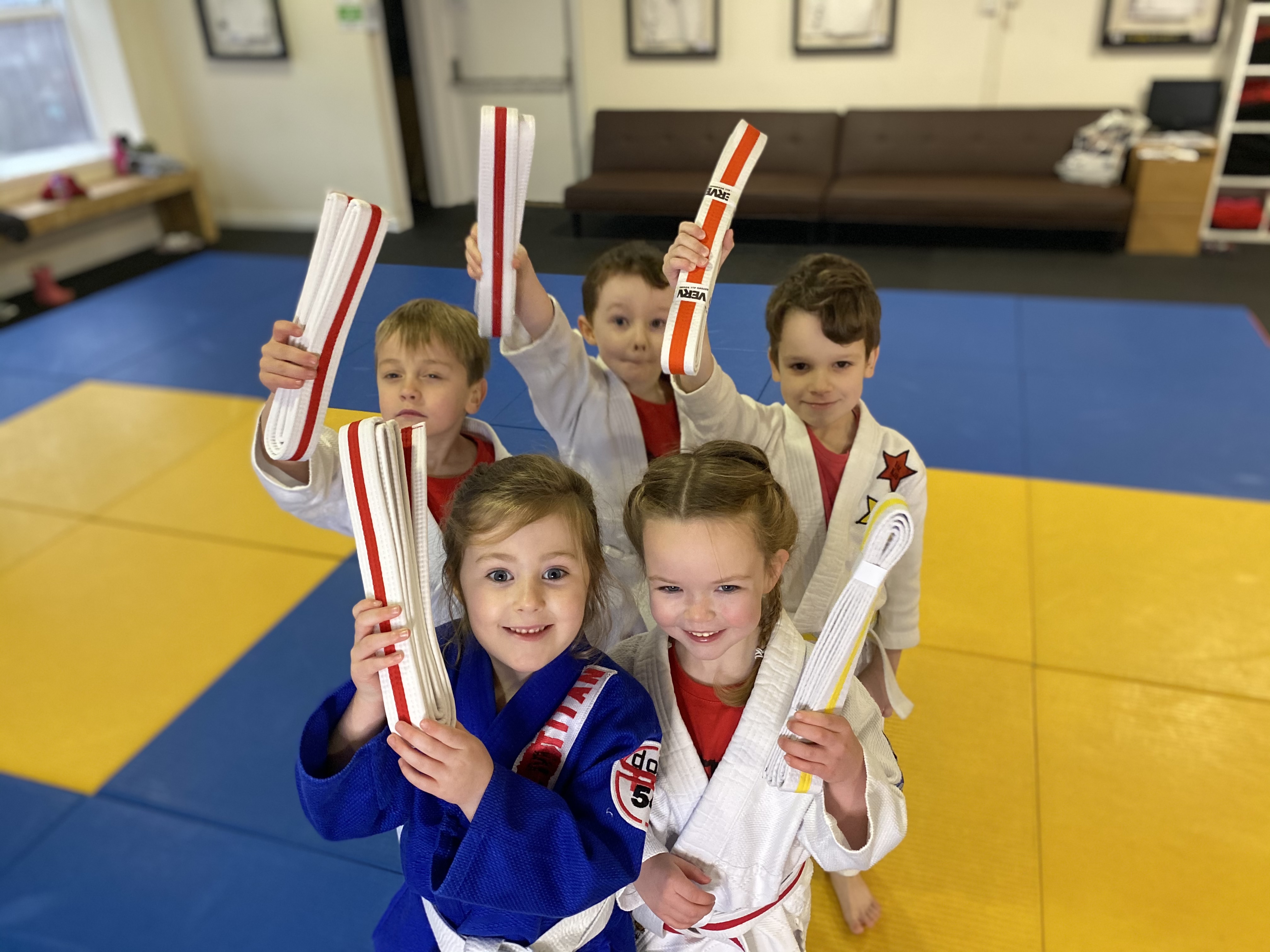 Children holding up their belts