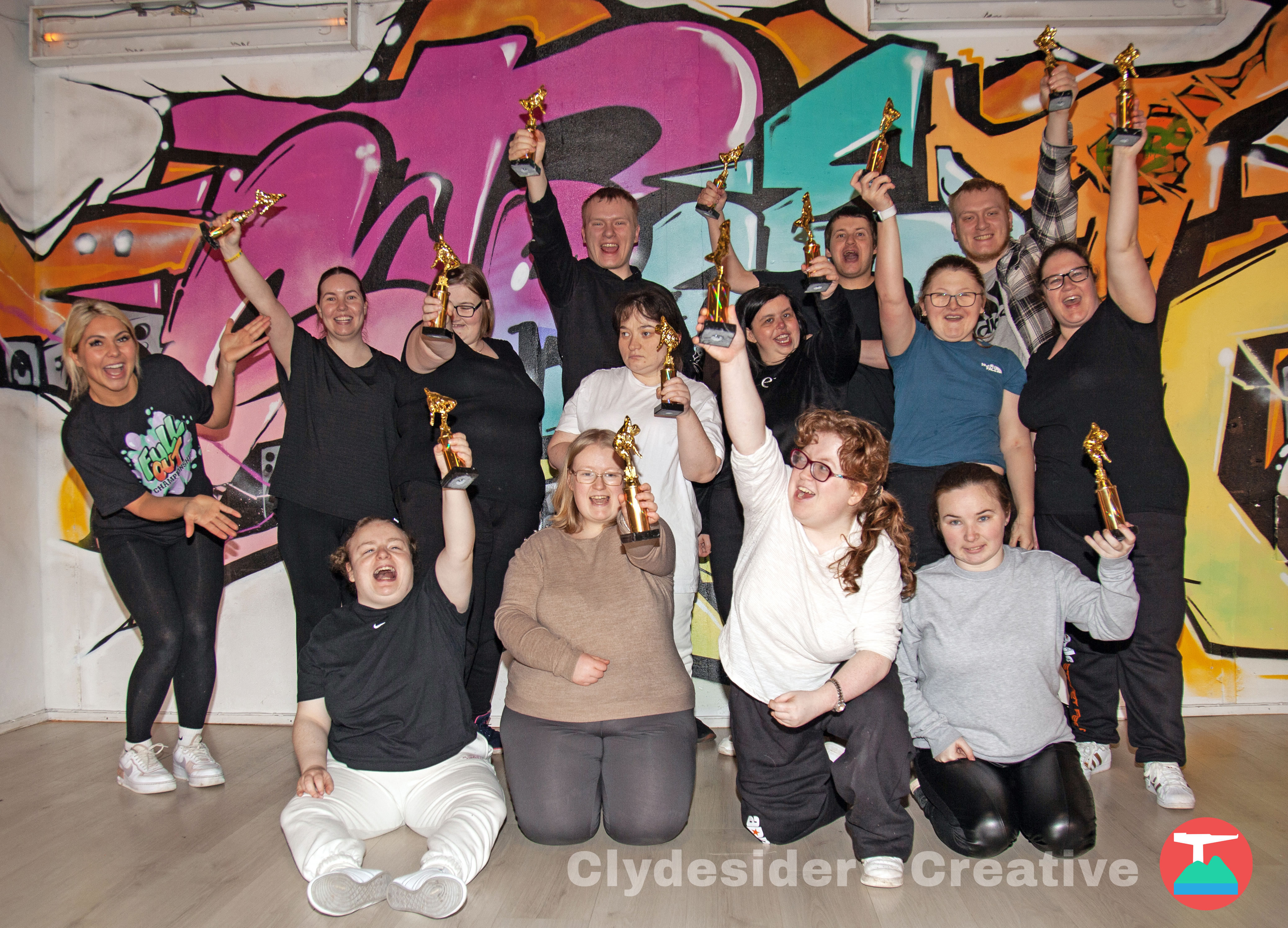 Award winning dancers holding up their trophies
