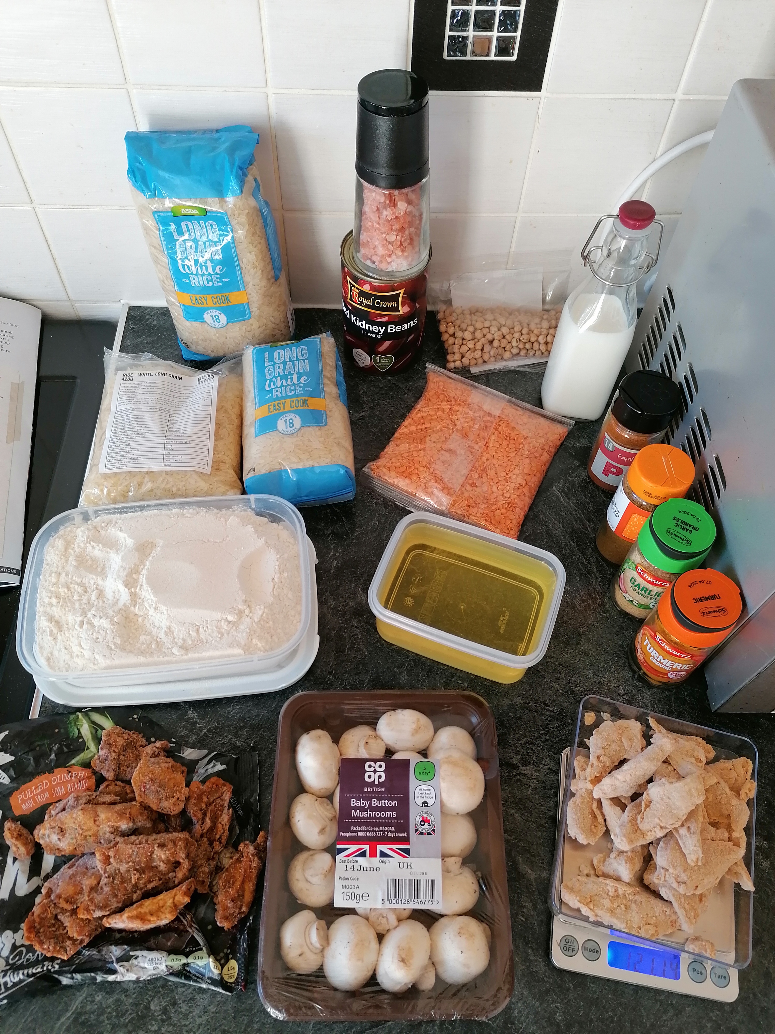 Ingredients from Refugee Ration Box sprawled out across a kitchen worktop.