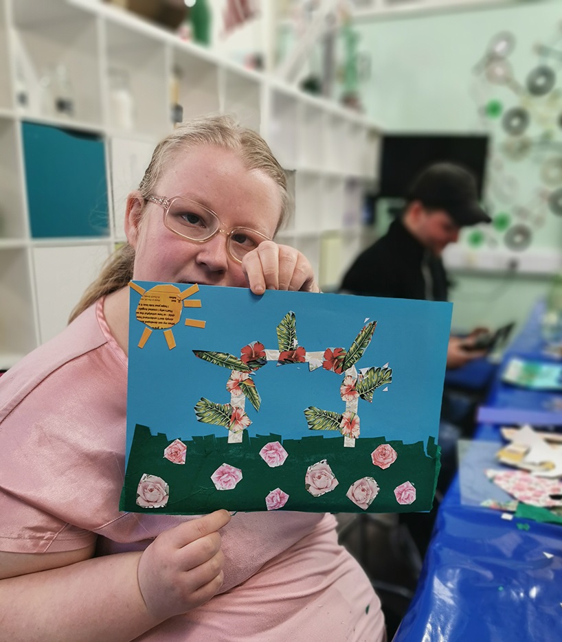 Unity group member holding up artwork they created 