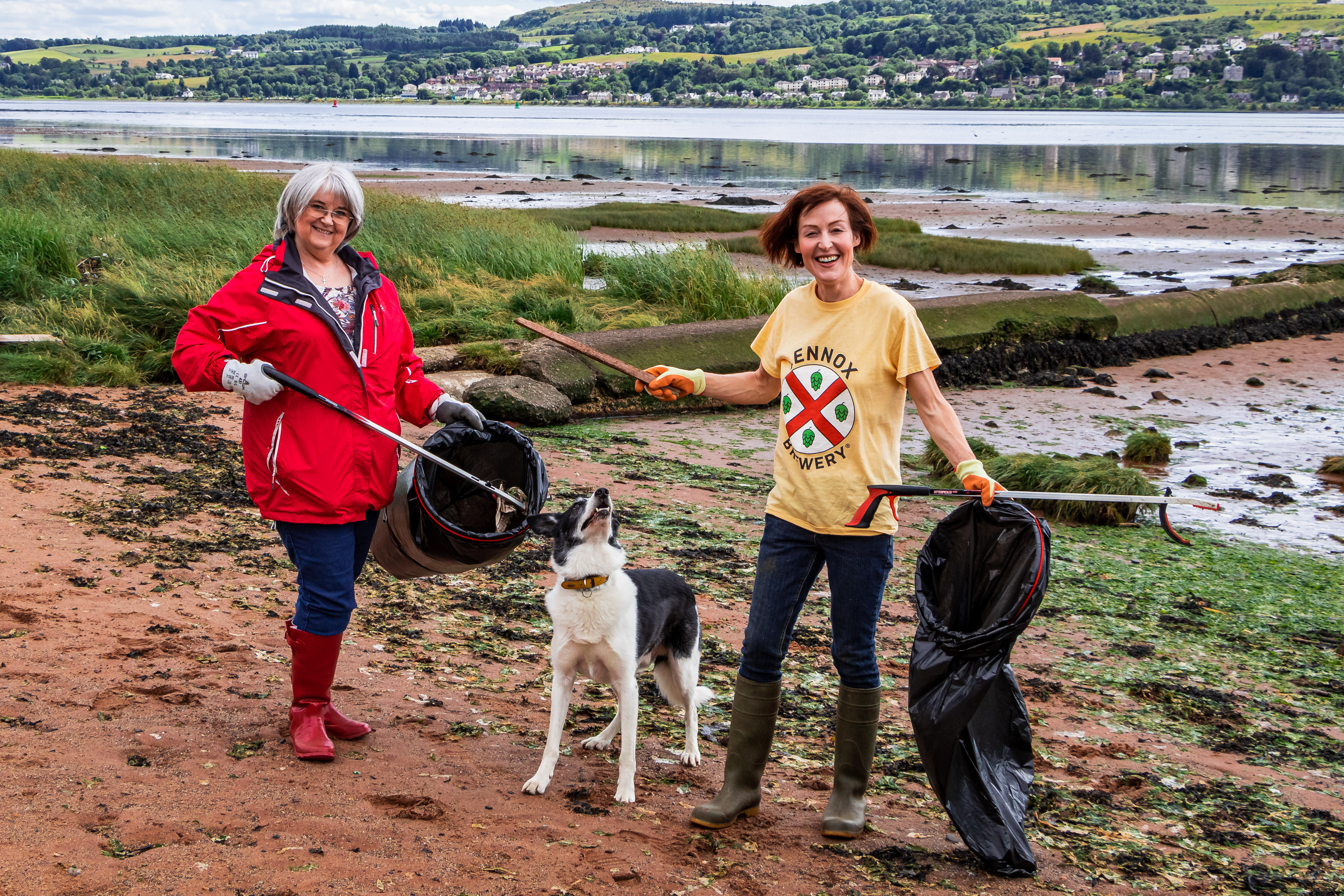 Two litter pickers and dog on Dumbarton foreshore