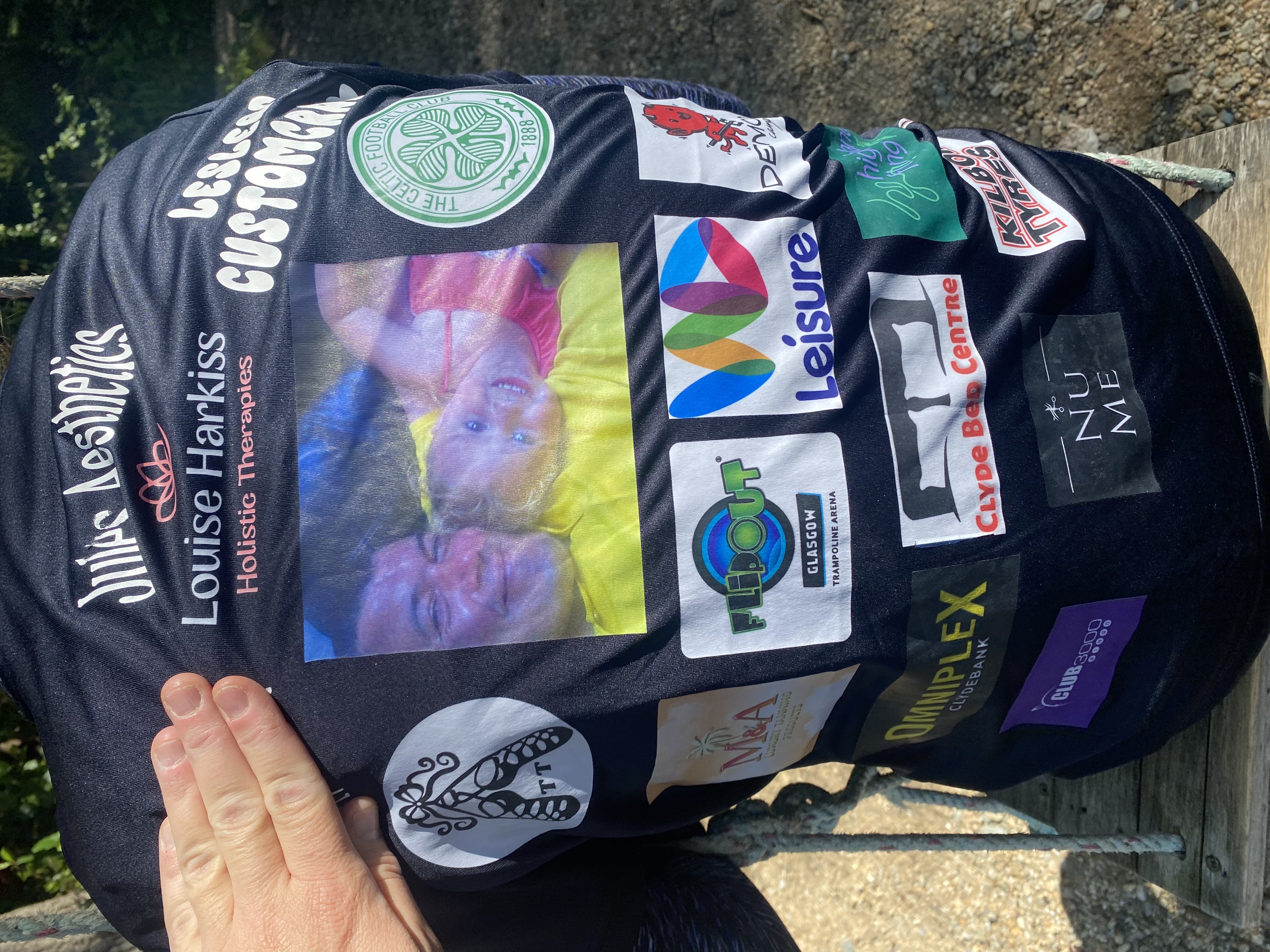 photo of the back of Courtney's t-shirt with all her sponsors logos on it. Plus a photo of her and her dad in the middle