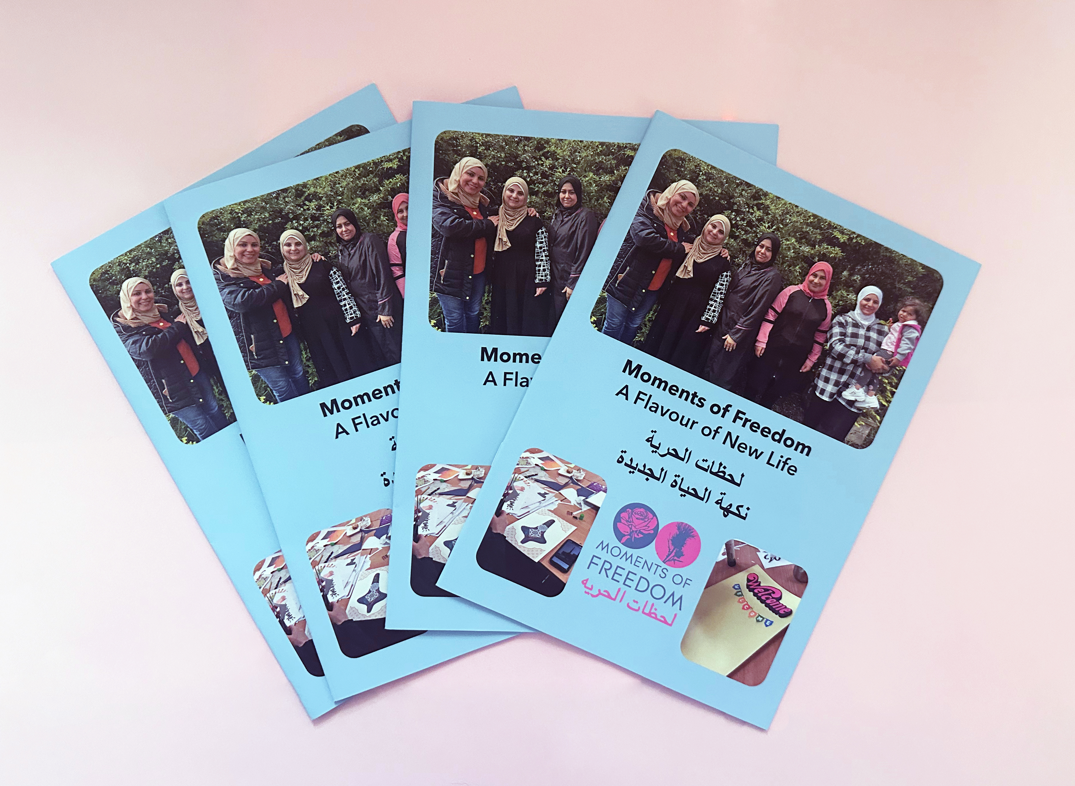 photo of four copies of the booklet laid out in a fan on a table