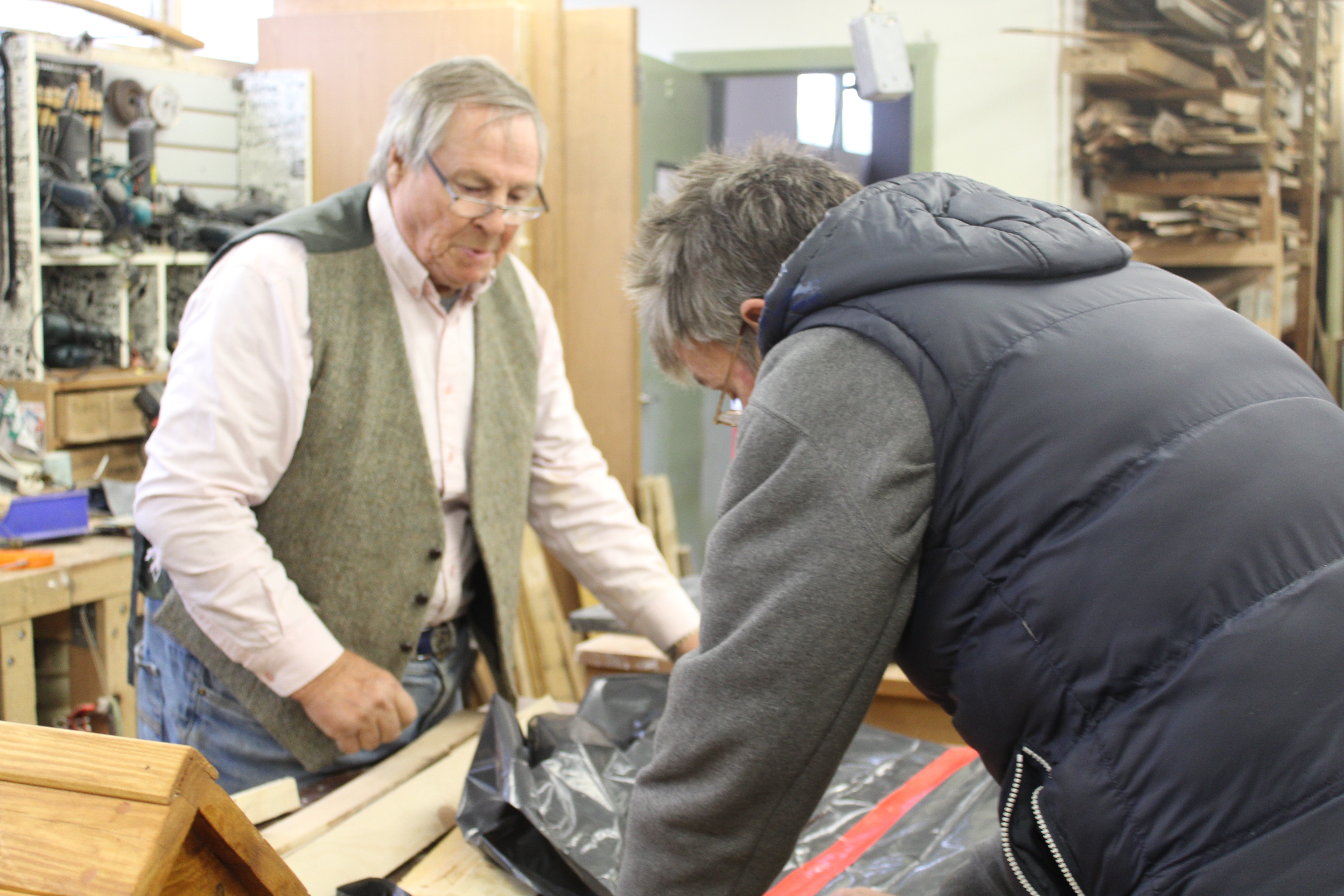 Two men building something together