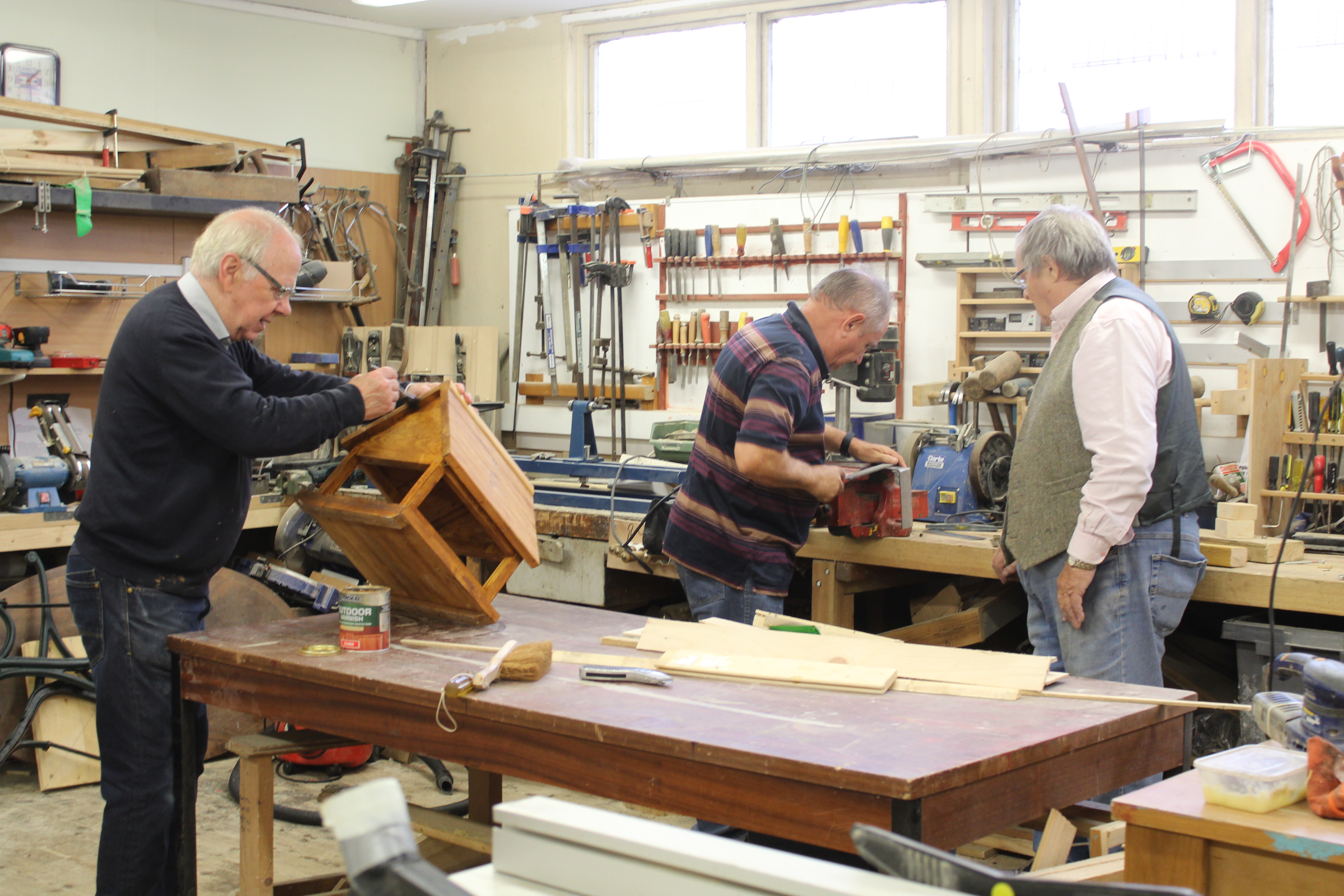 Men working away in the tool shed