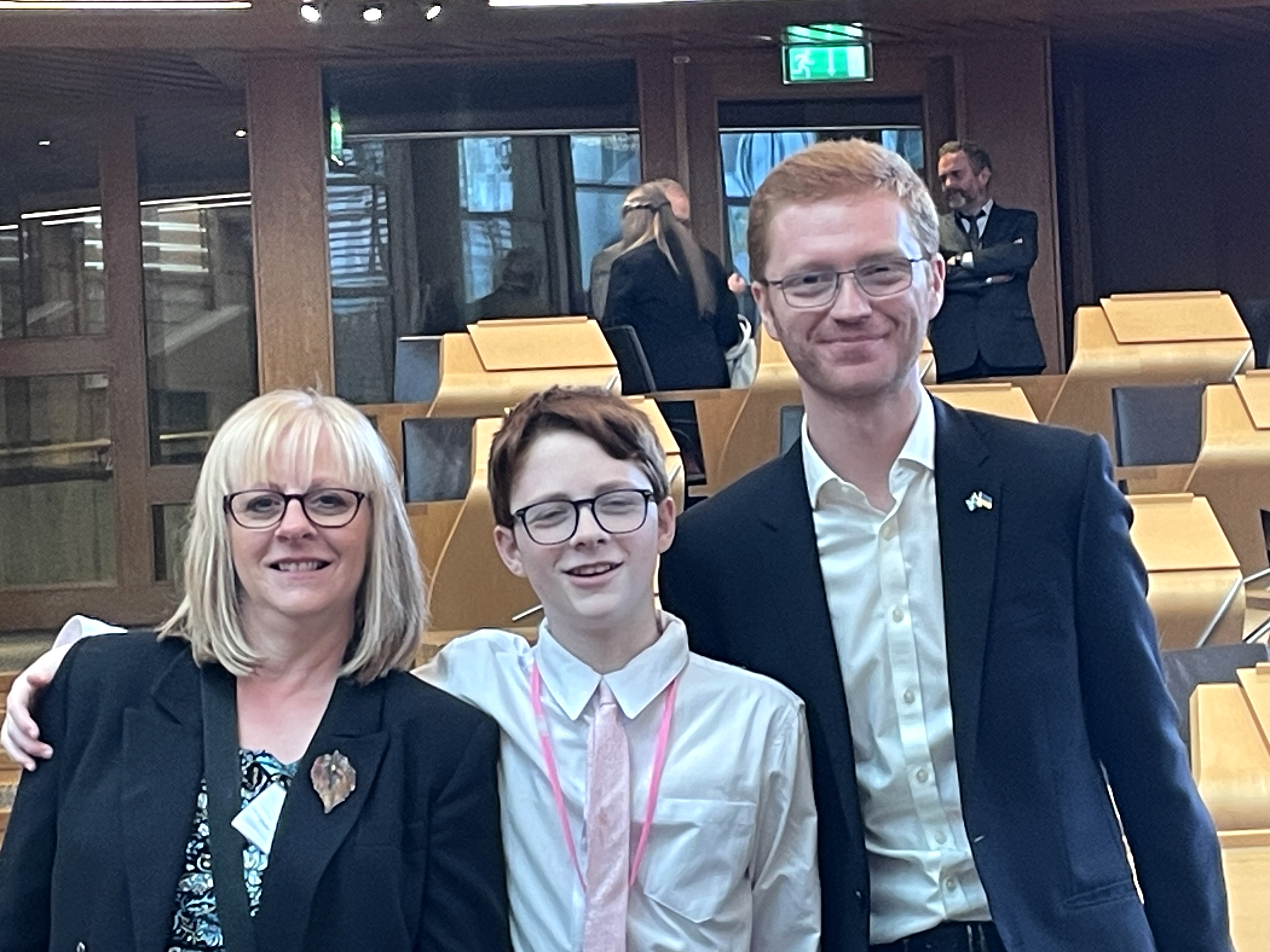 Sam, her son Christopher and Green MSP Ross Greer in the Scottish Parliament