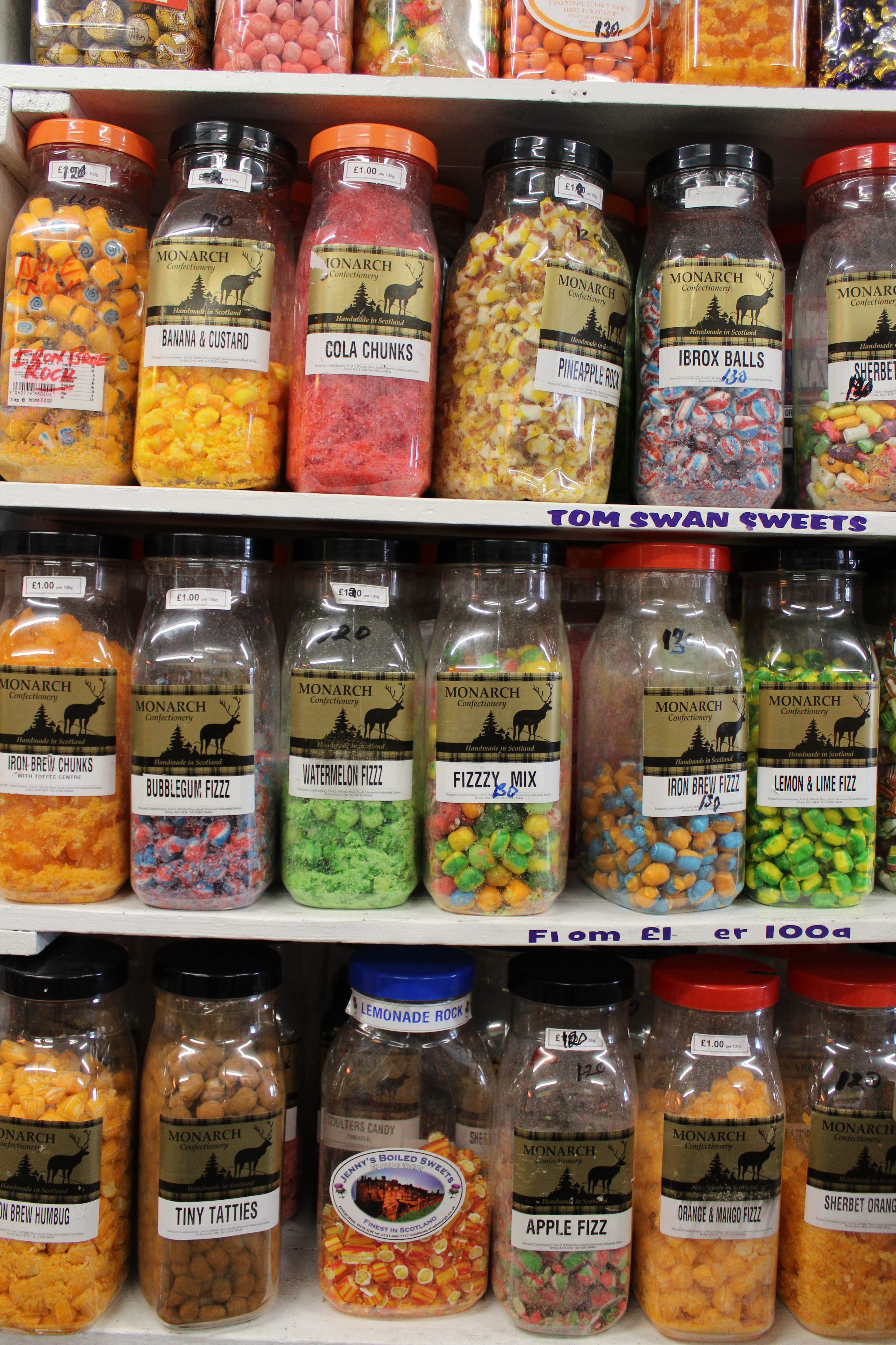 four shelves filled with tubs of sweets