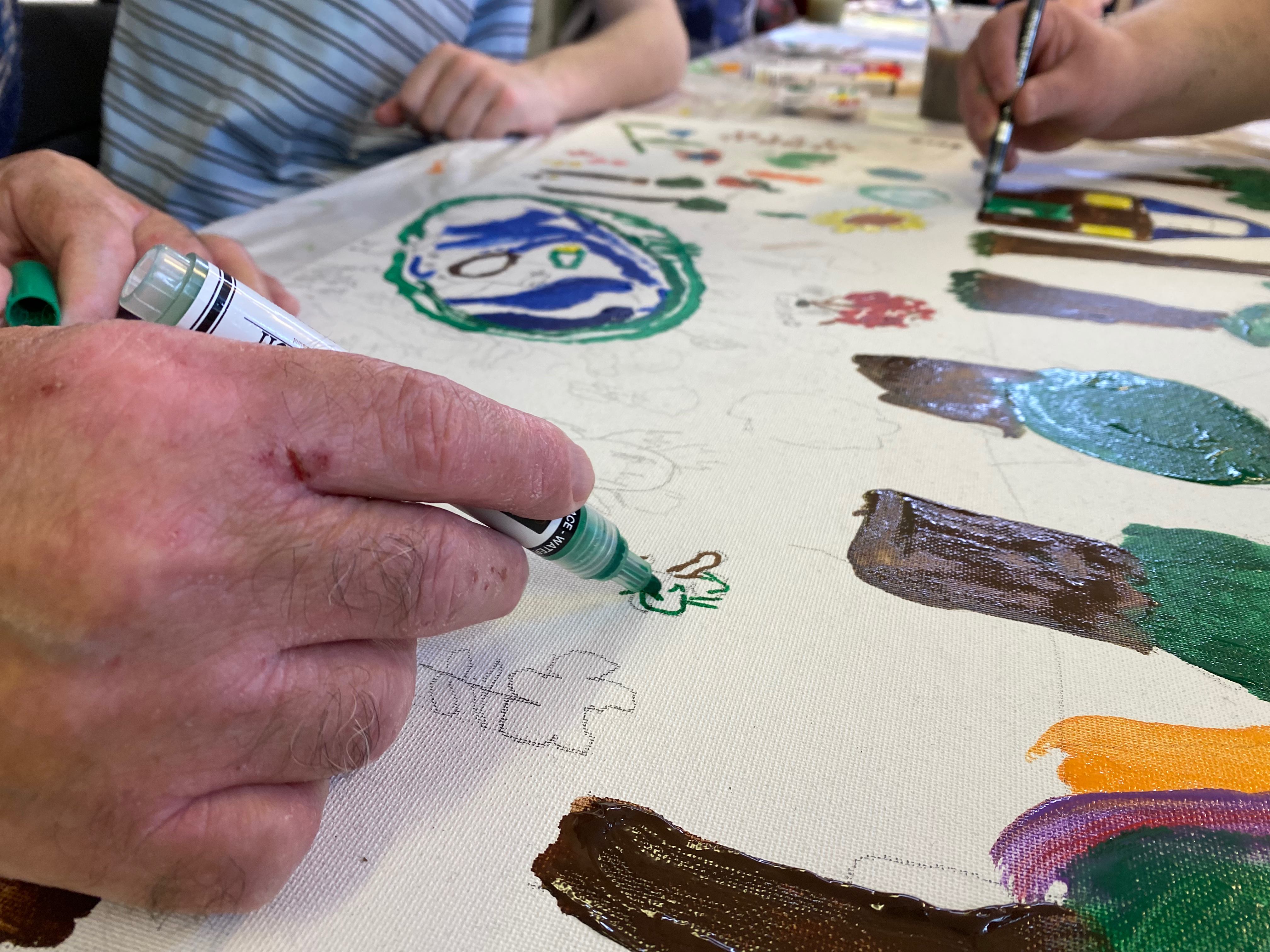 close up of hand using a pen to draw a flower