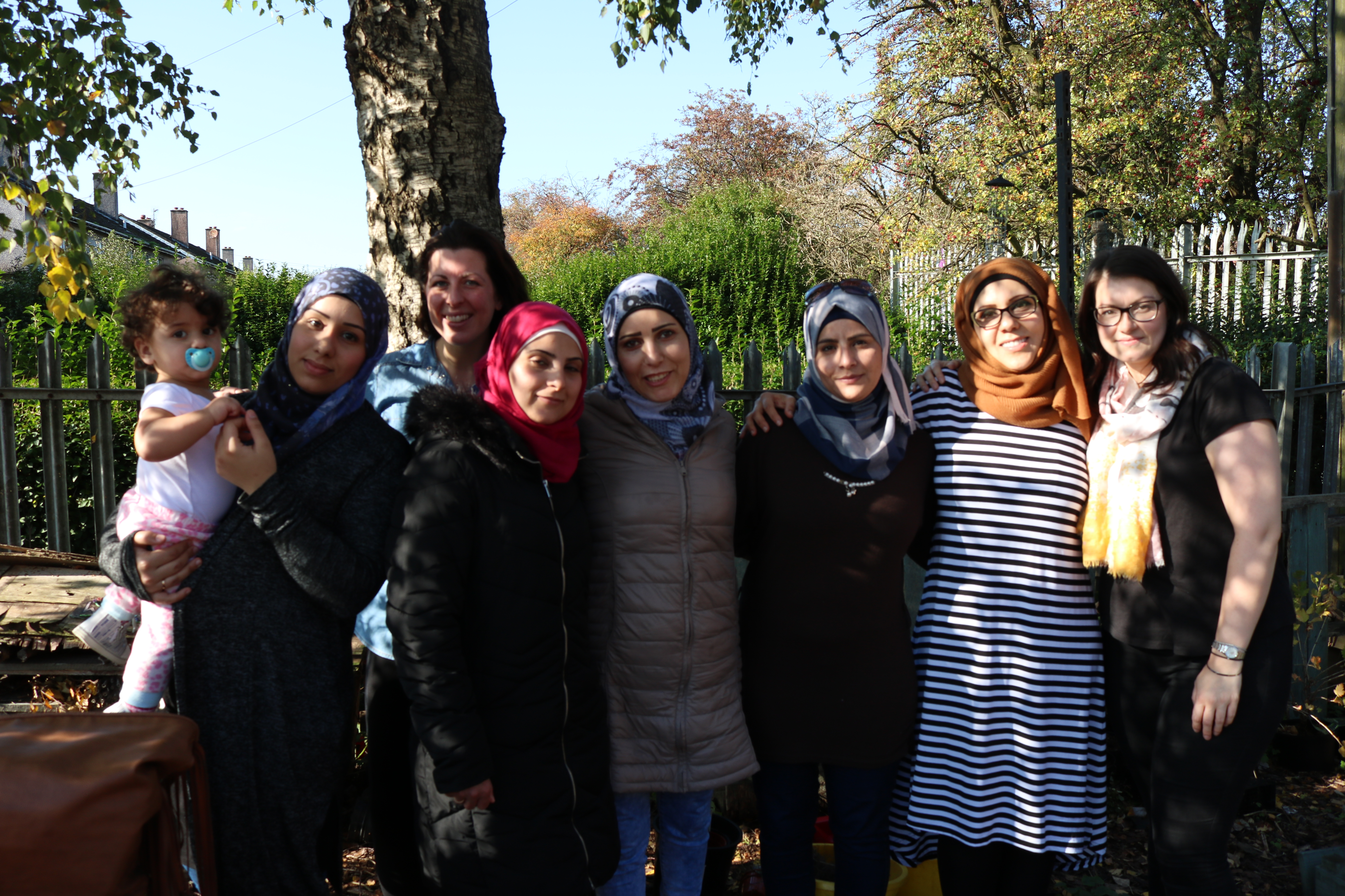 A group of women from Moments of Freedom posing for a photo outside.