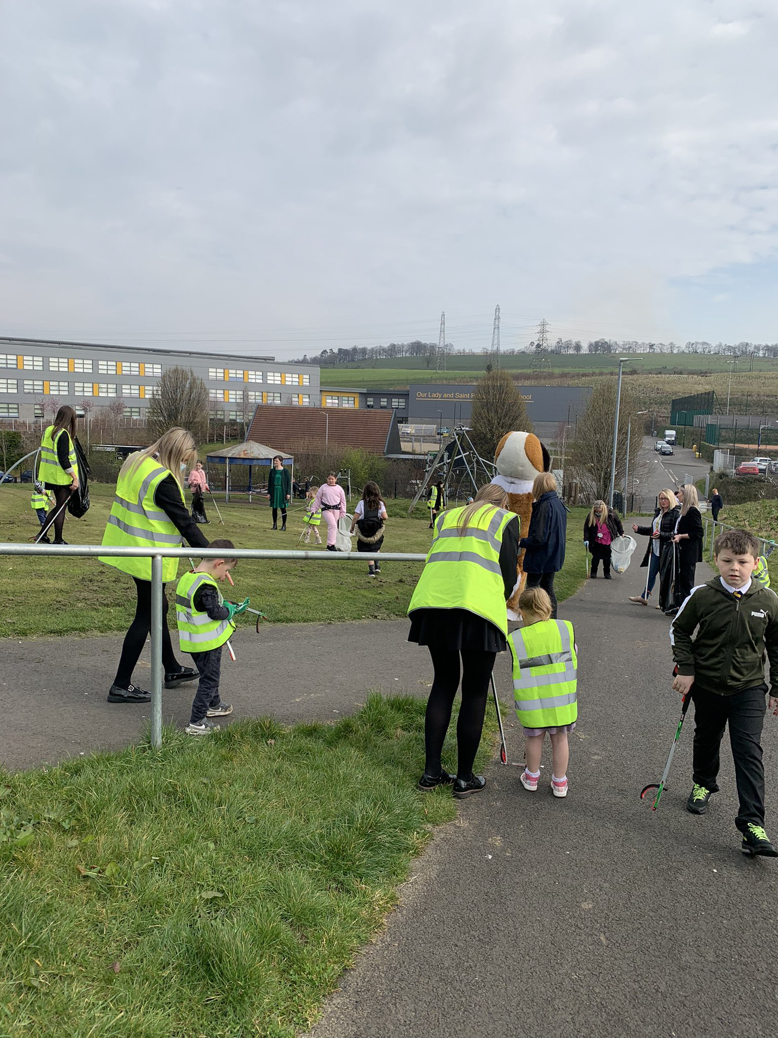 children and teachers out on a litter pick
