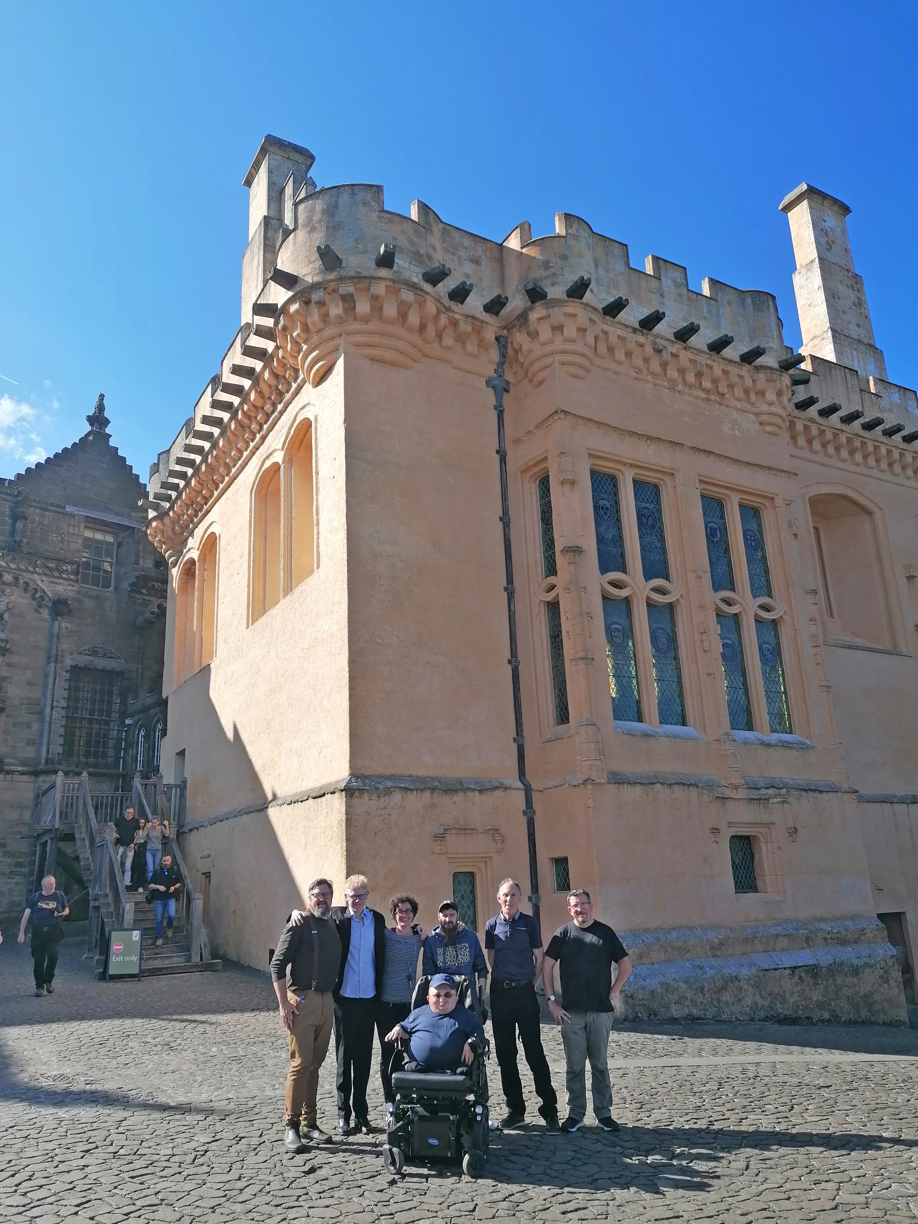 group of people standing in front of Stirling Castle