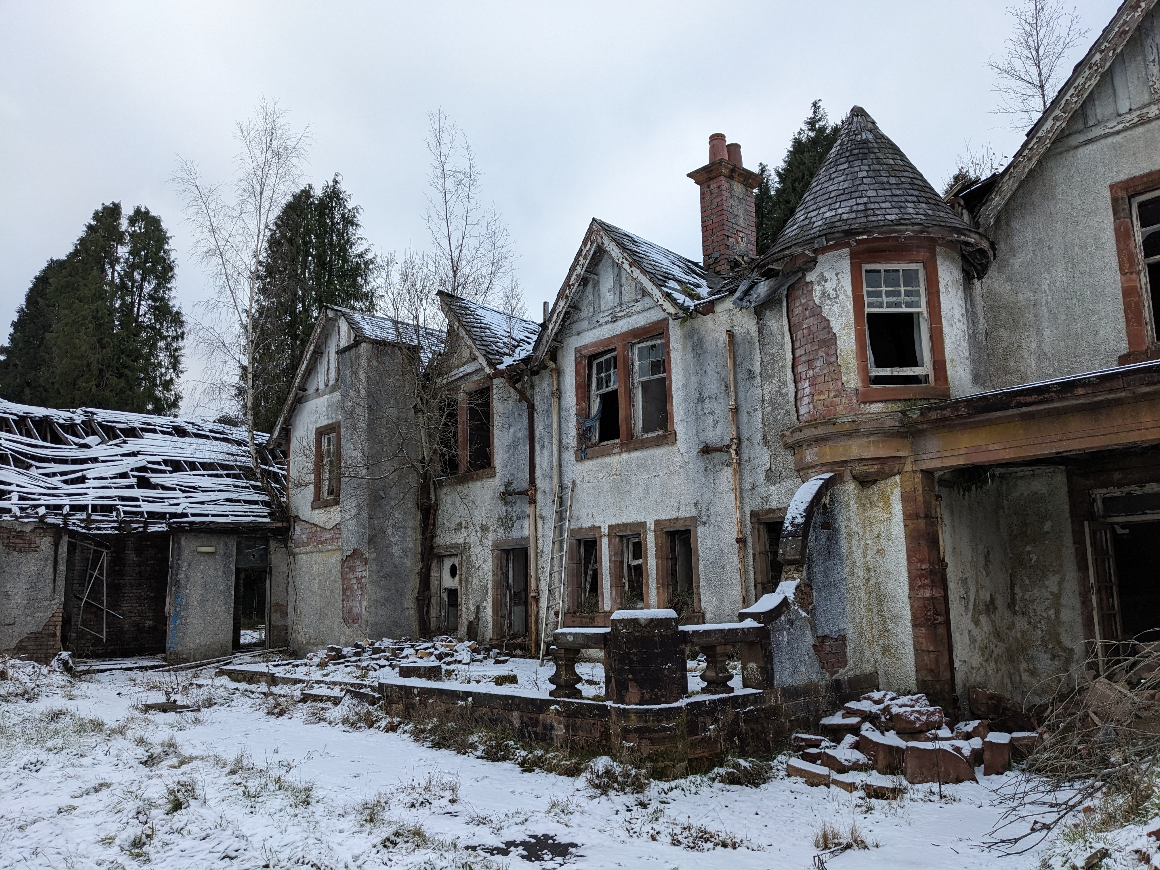 photograph of a derelict yellow sandstone building covered in frost and snow