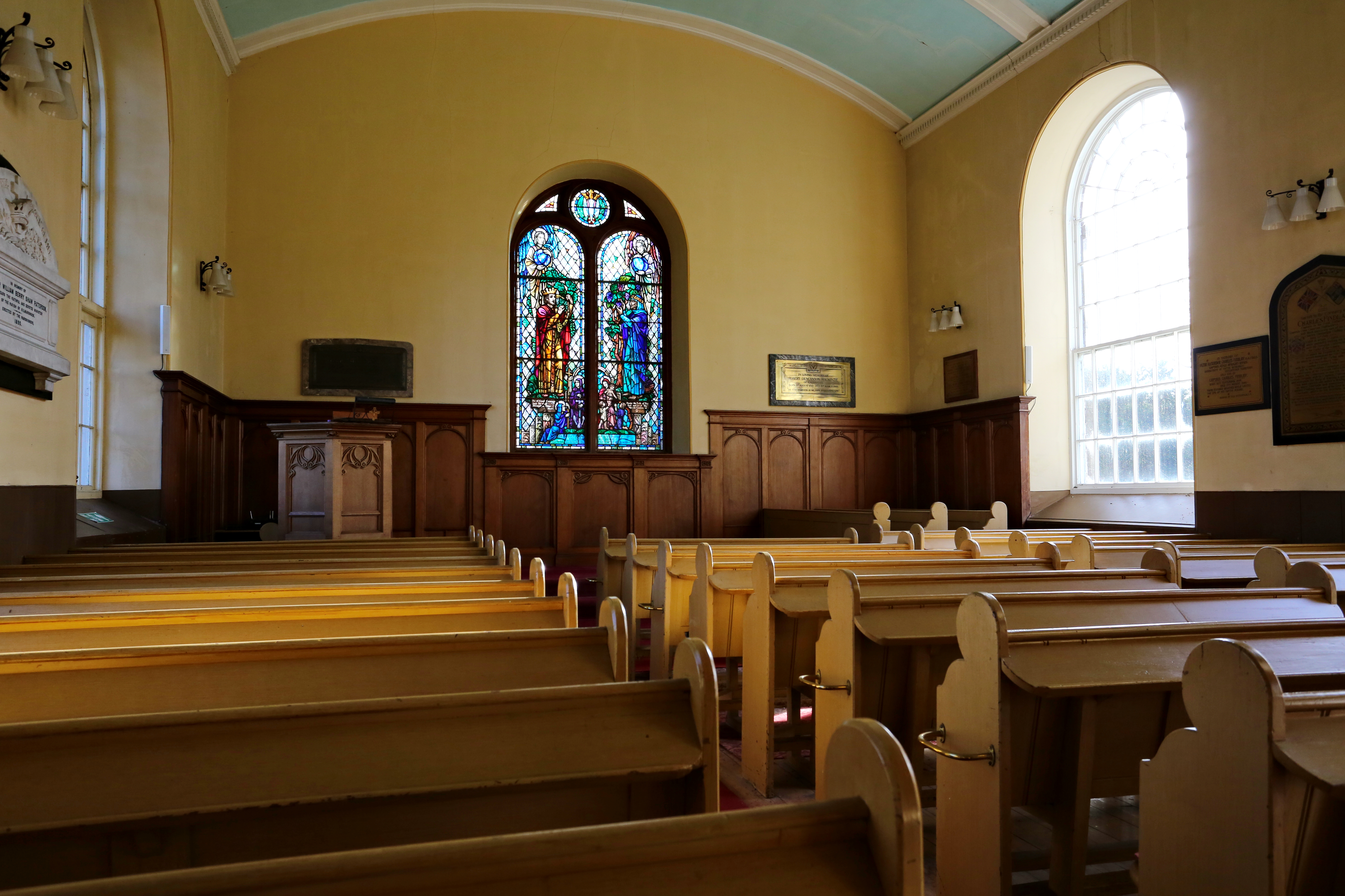 inside the Kirk looking up to the alter and beautiful stained glass window behind it