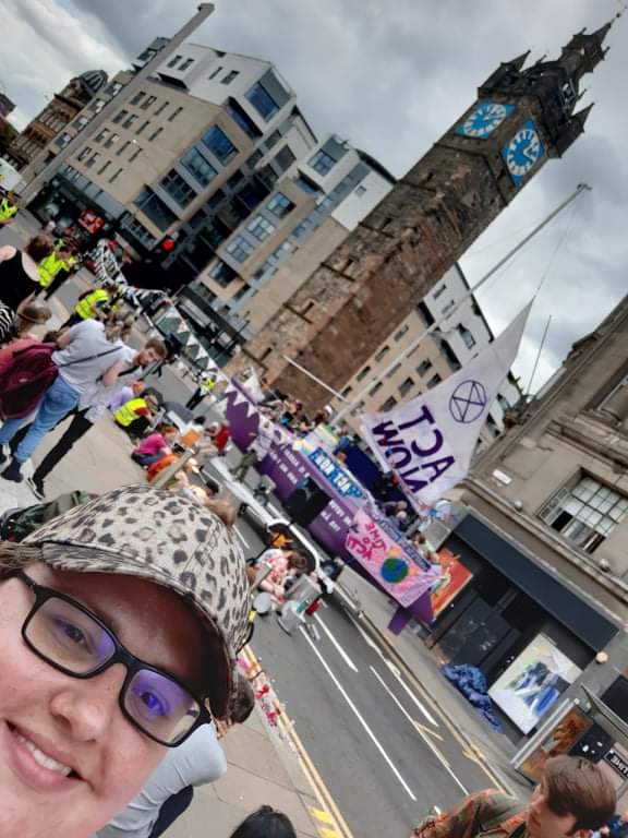 Selfie of Emily with protesters behind