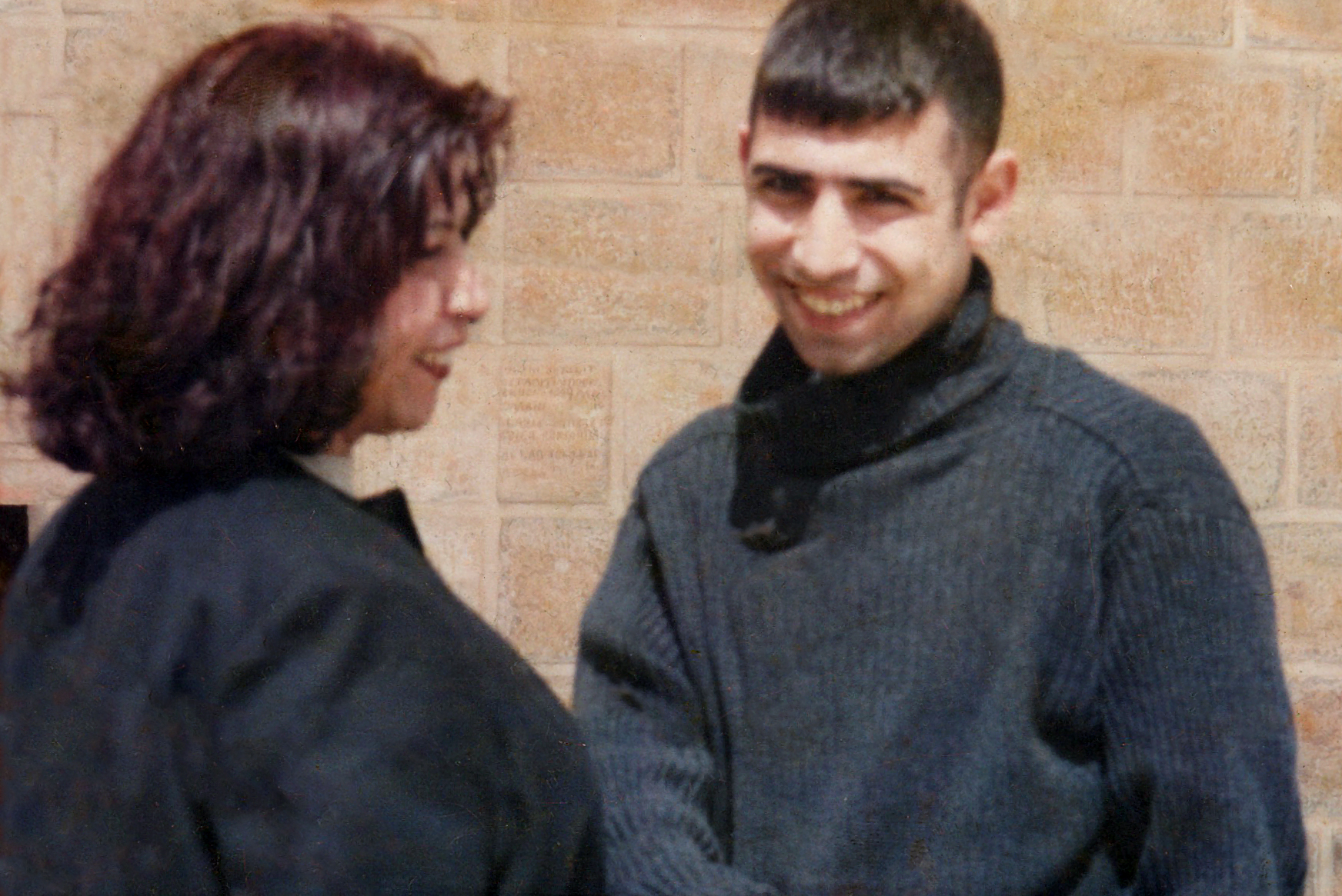 Simon standing laughing with his mum