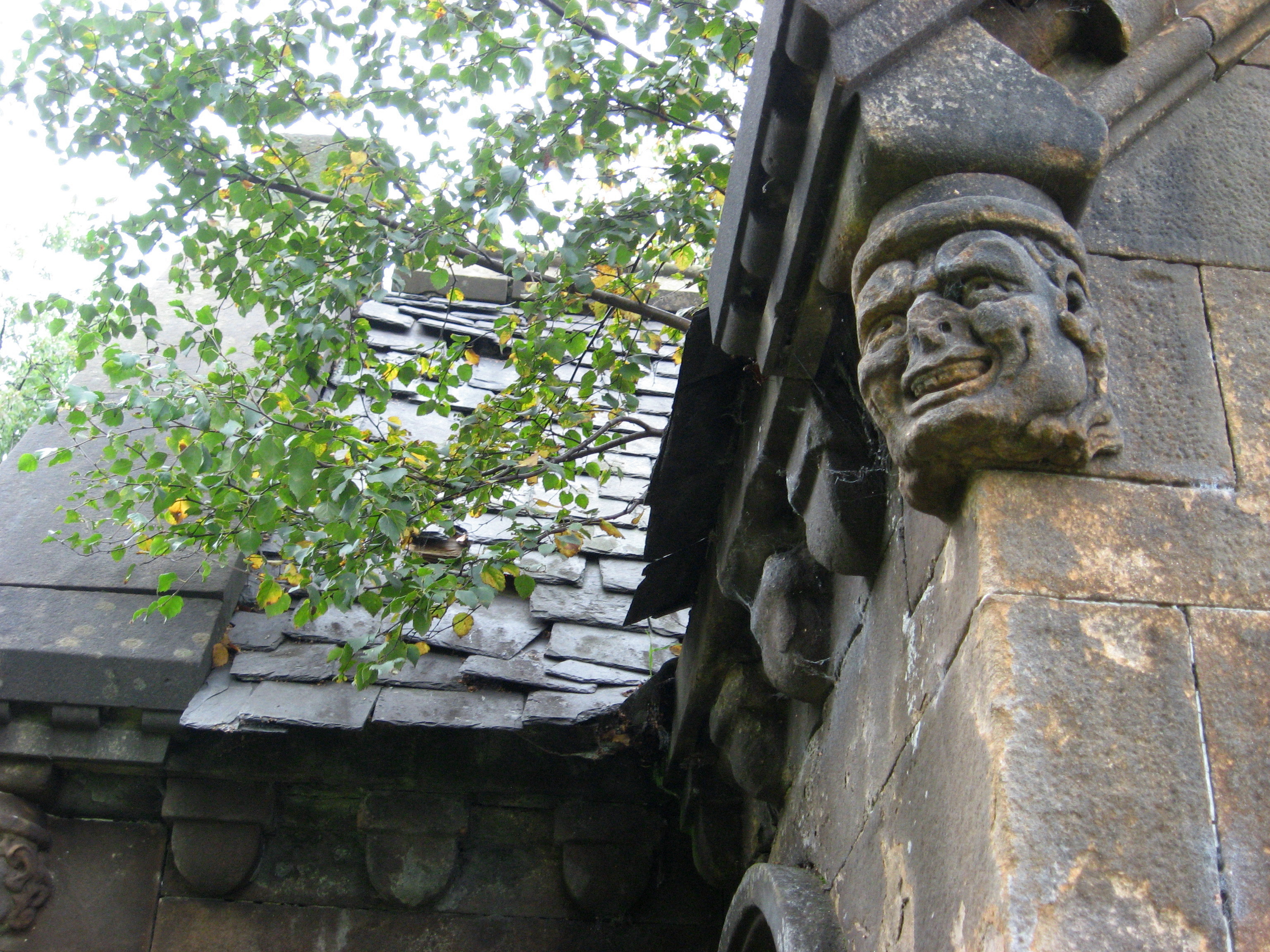 close up on carving of a face on the corner of the building