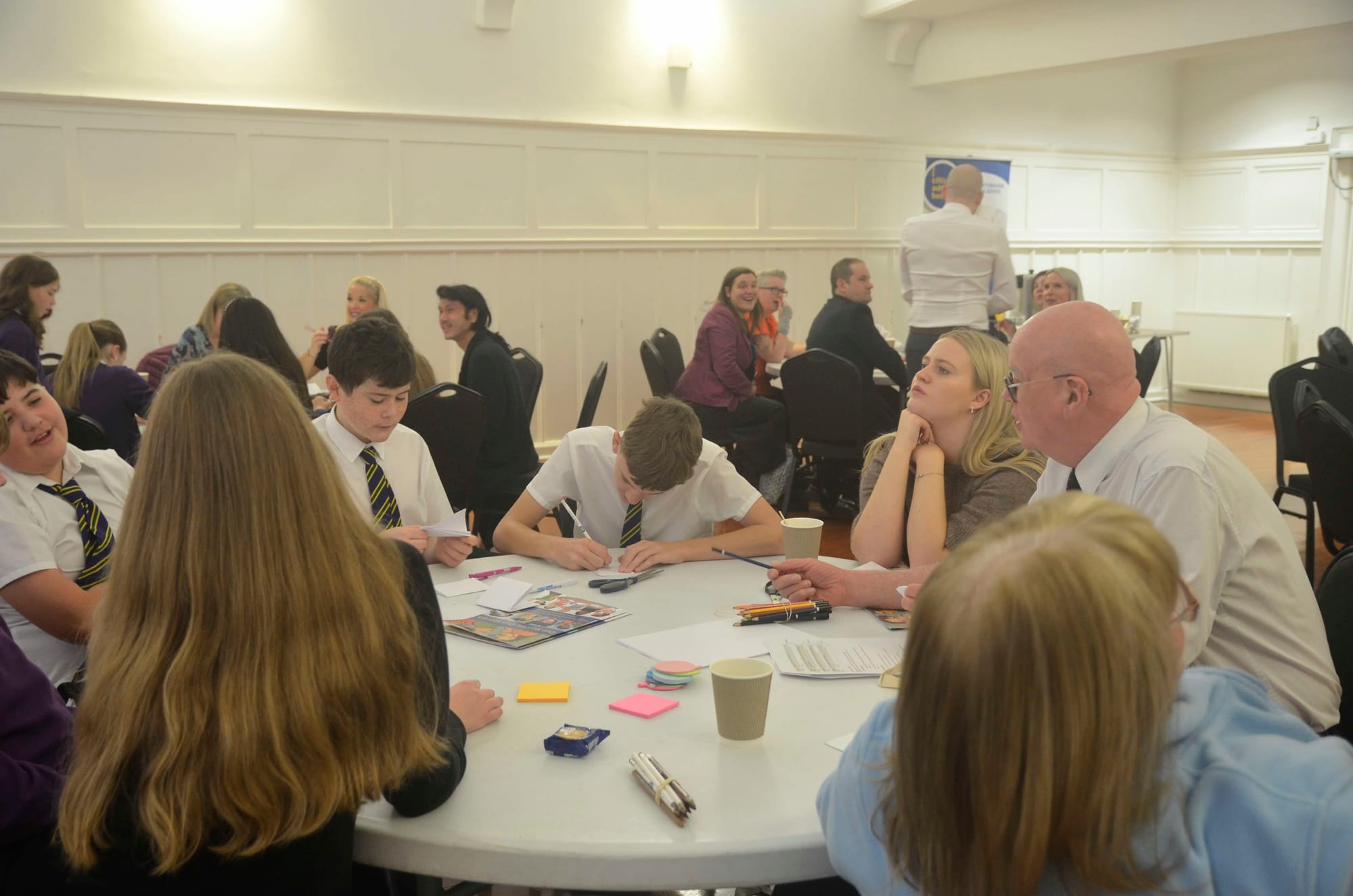 S1 & S2 pupils sitting round a table talking with Joe from CAB
