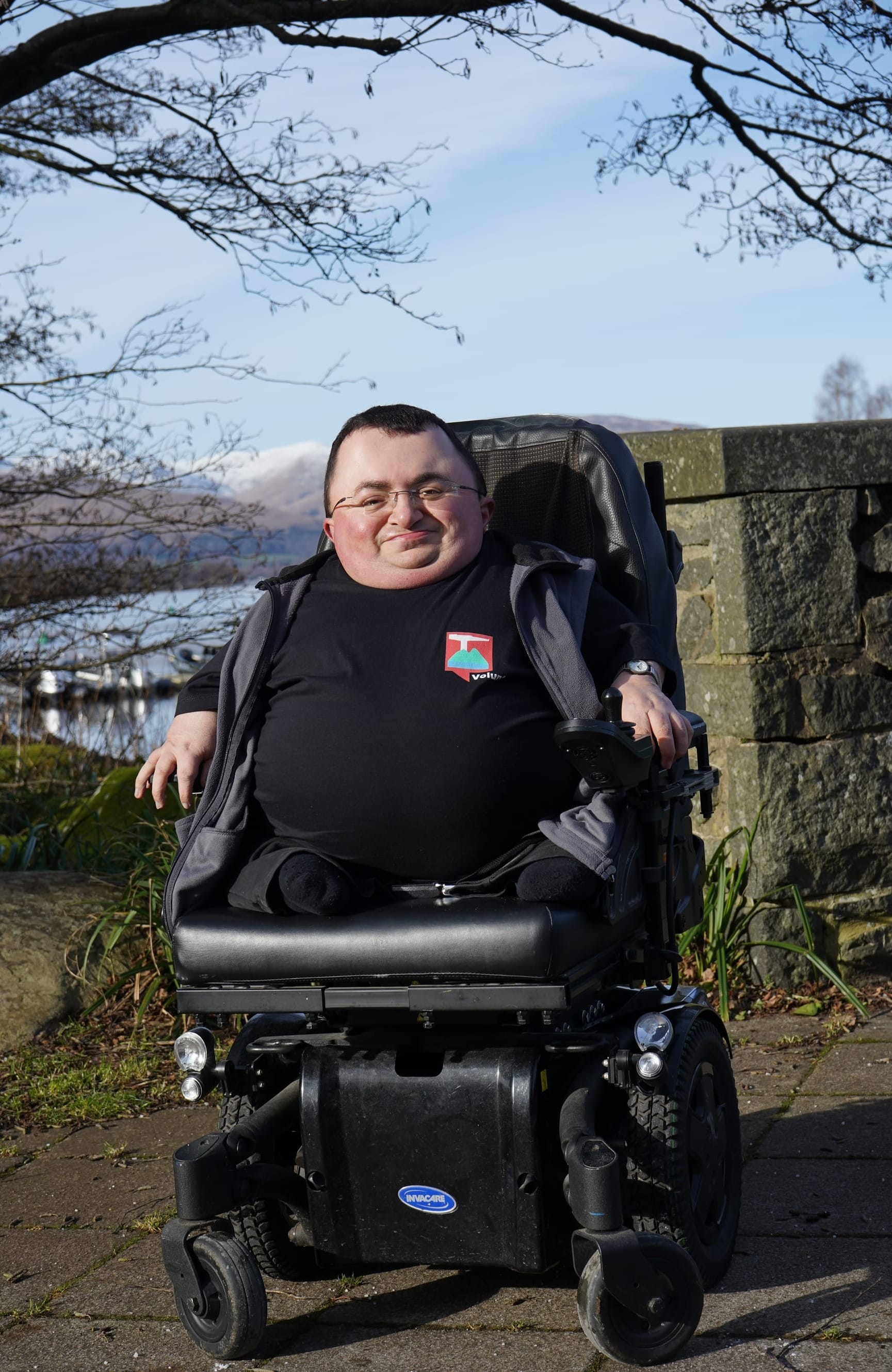 Steven sitting in his wheelchair with Loch Lomond in the background