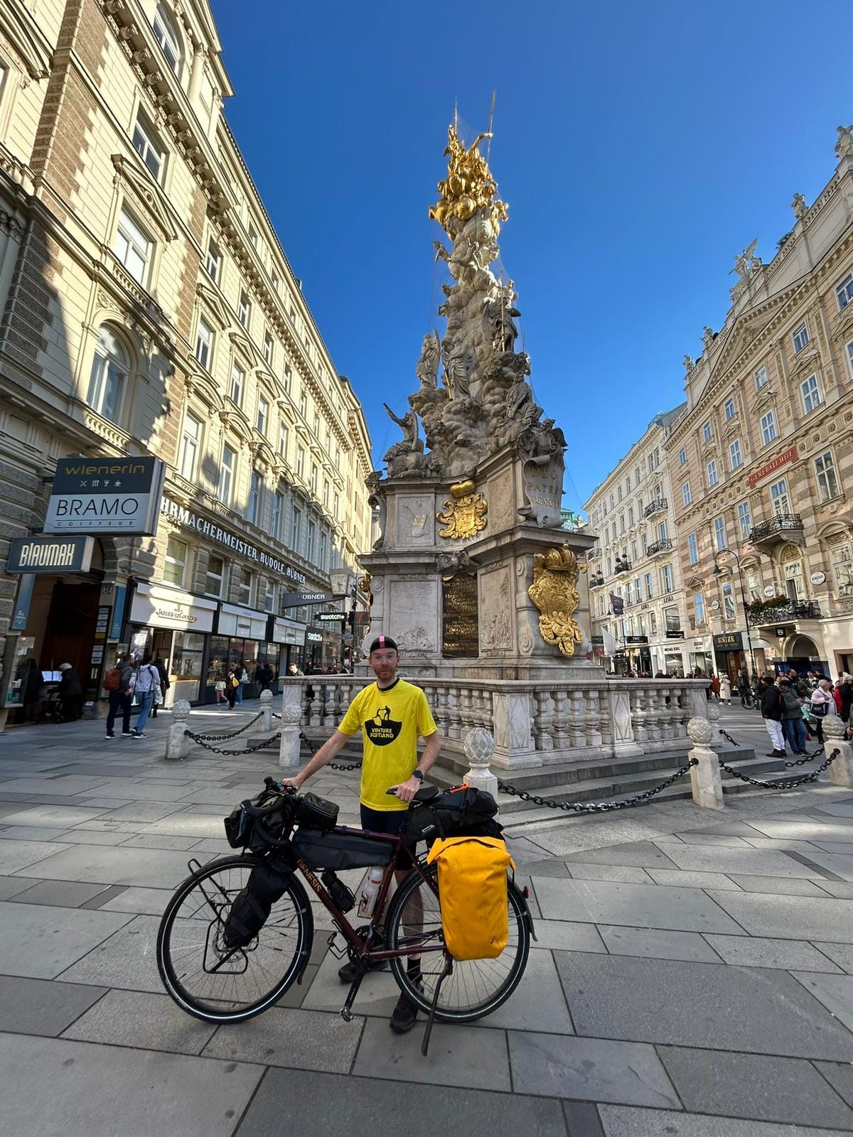 Connor standing in front of a beautiful town statue