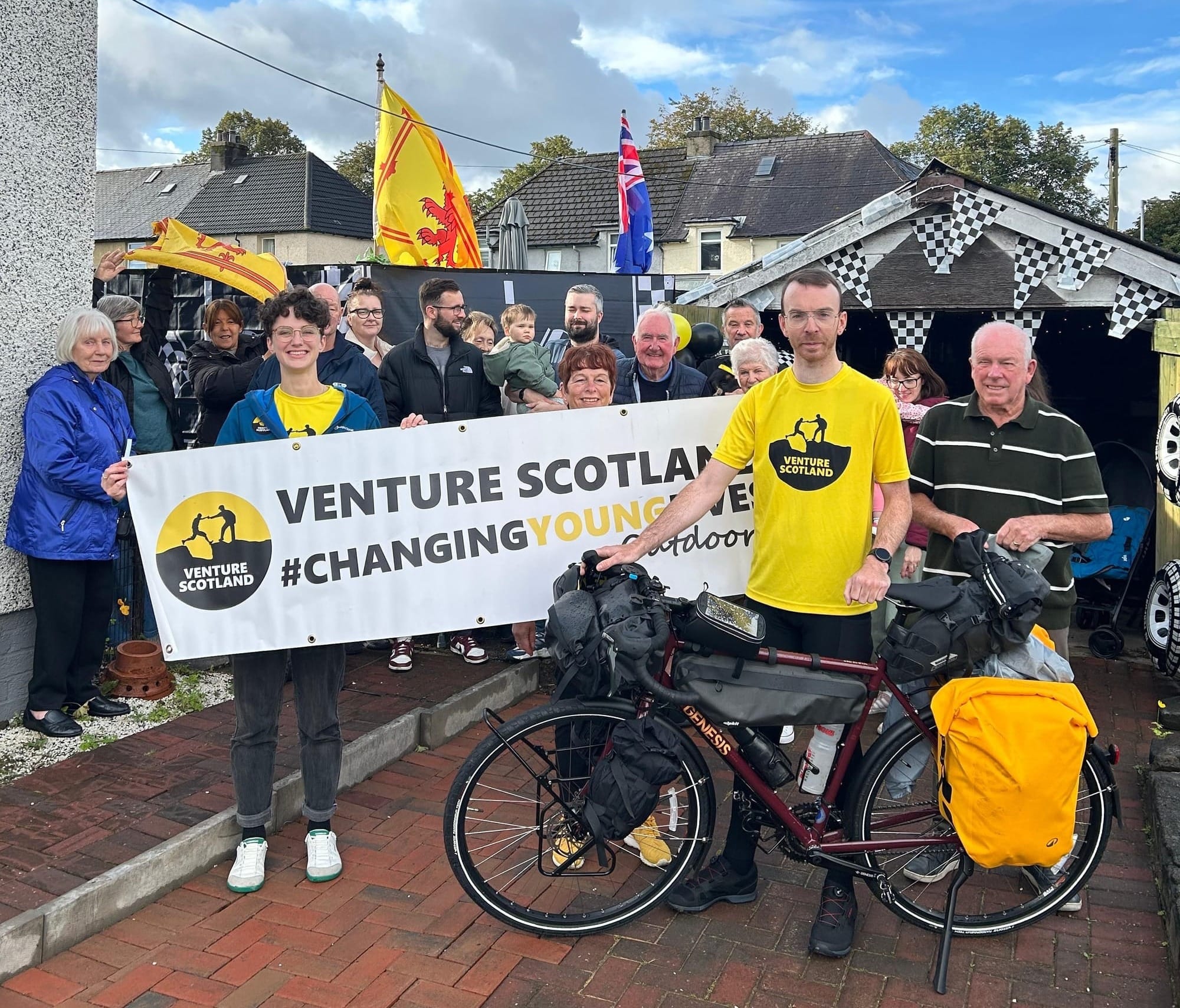 Connor standing in a large group of his family and friends.