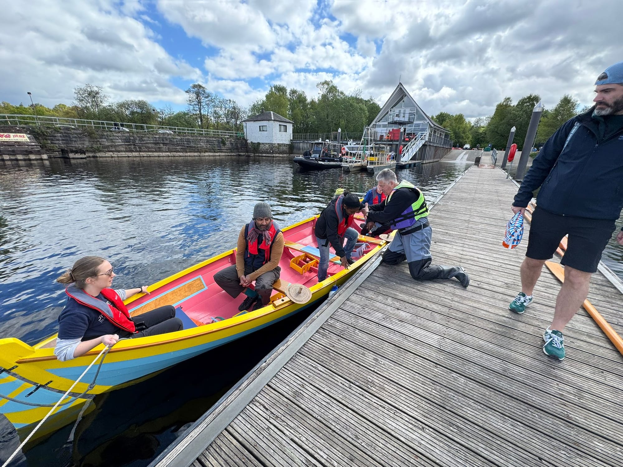 Suhaila being helped out of the skiff moored at Balloch pier