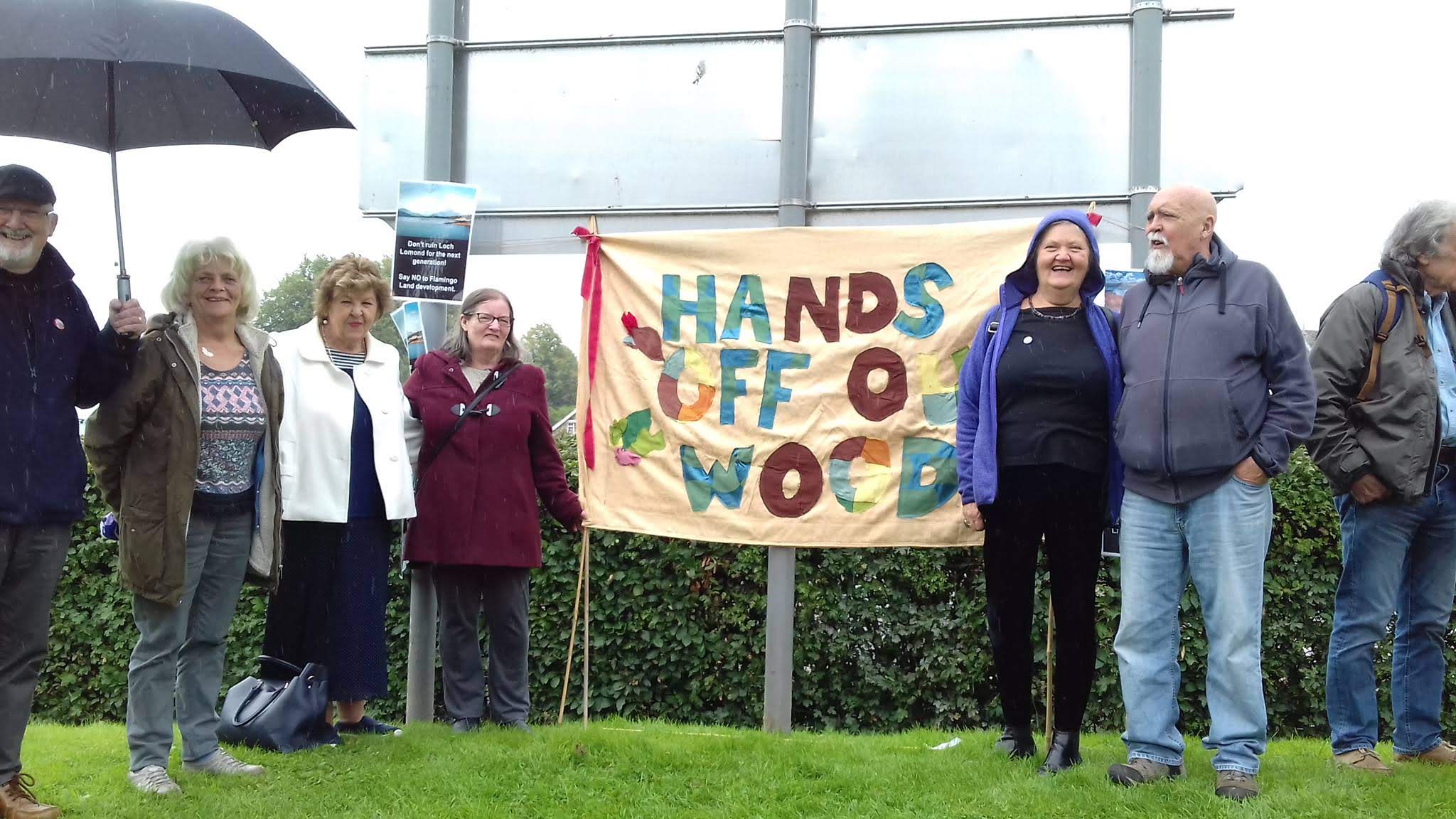Louise, Les and friends standing together outside on grass during a demonstration to save Drumkinnon woods